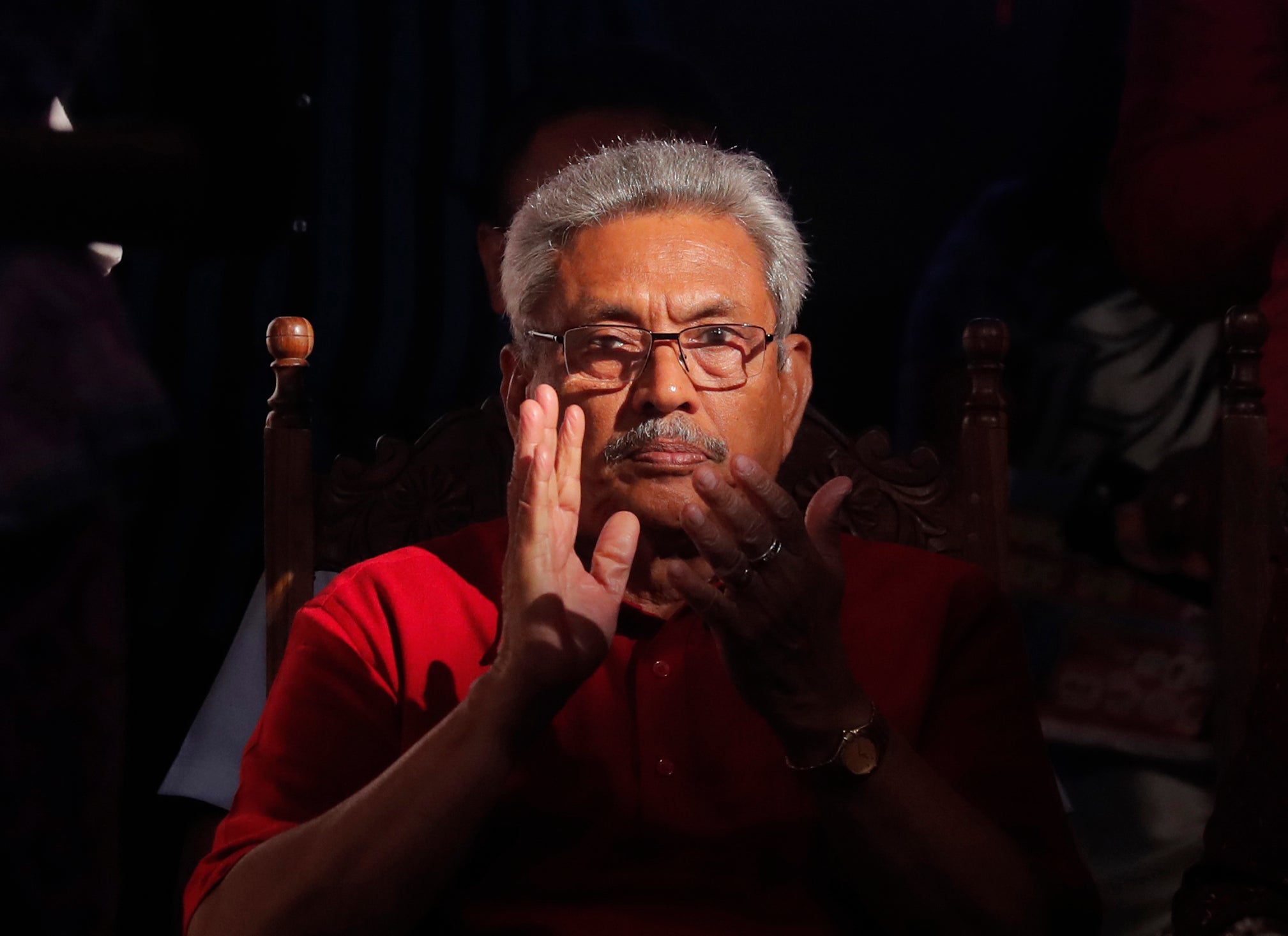 A older man in glasses clapping