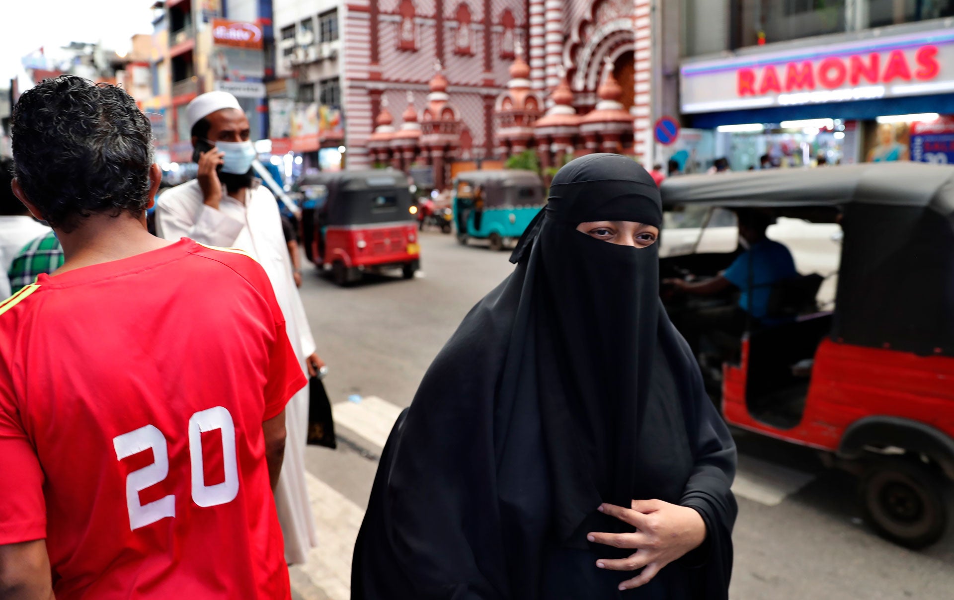 A Sri Lankan Muslim woman wearing a burka walks in a street in Colombo, Sri Lanka