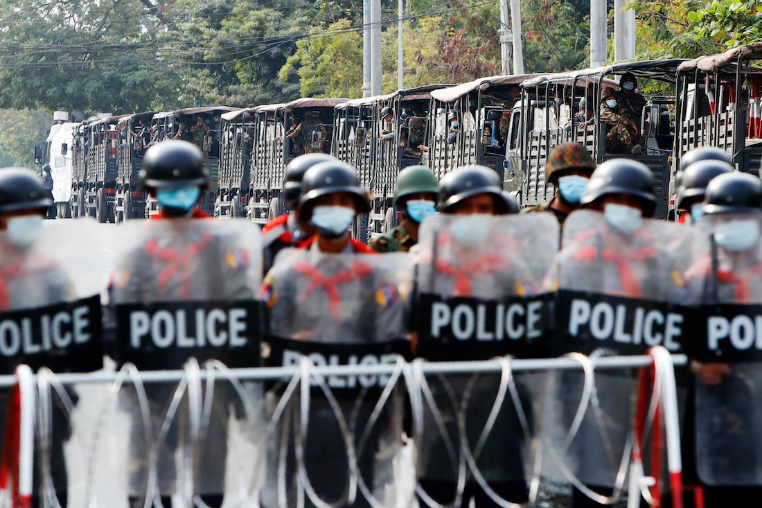 Soldiers and police stand guard behind a road barricade in Mandalay, Myanmar, February 19, 2021.