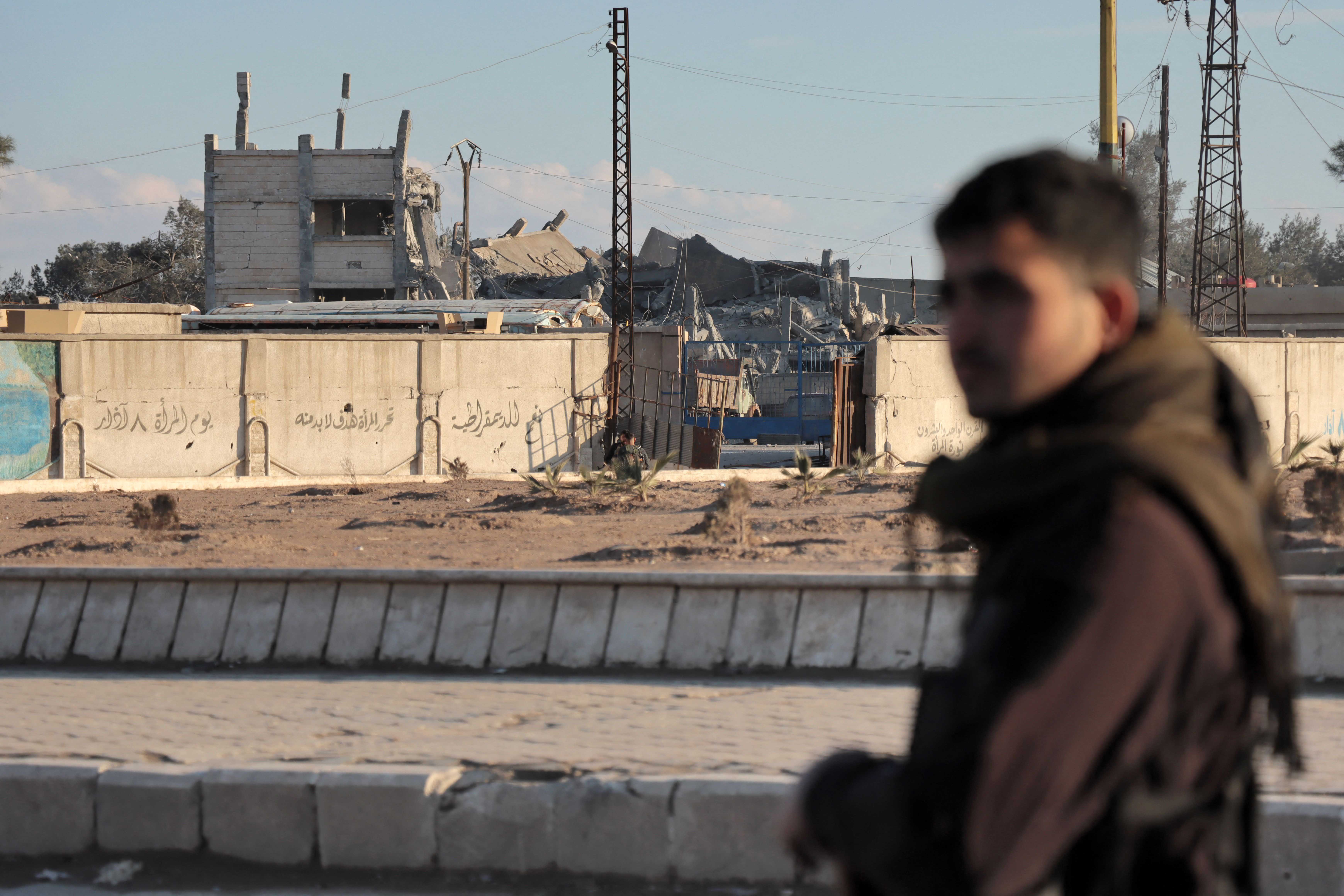Fighters with the Kurdish-led Syrian Democratic Forces deploy around al-Sina’a prison in the Ghweran district of al-Hasakah, northeast Syria, on January 25, 2022, midway through the 10-day battle to recapture it from the Islamic State (ISIS). © 2022 AFP Photo via Getty Images
