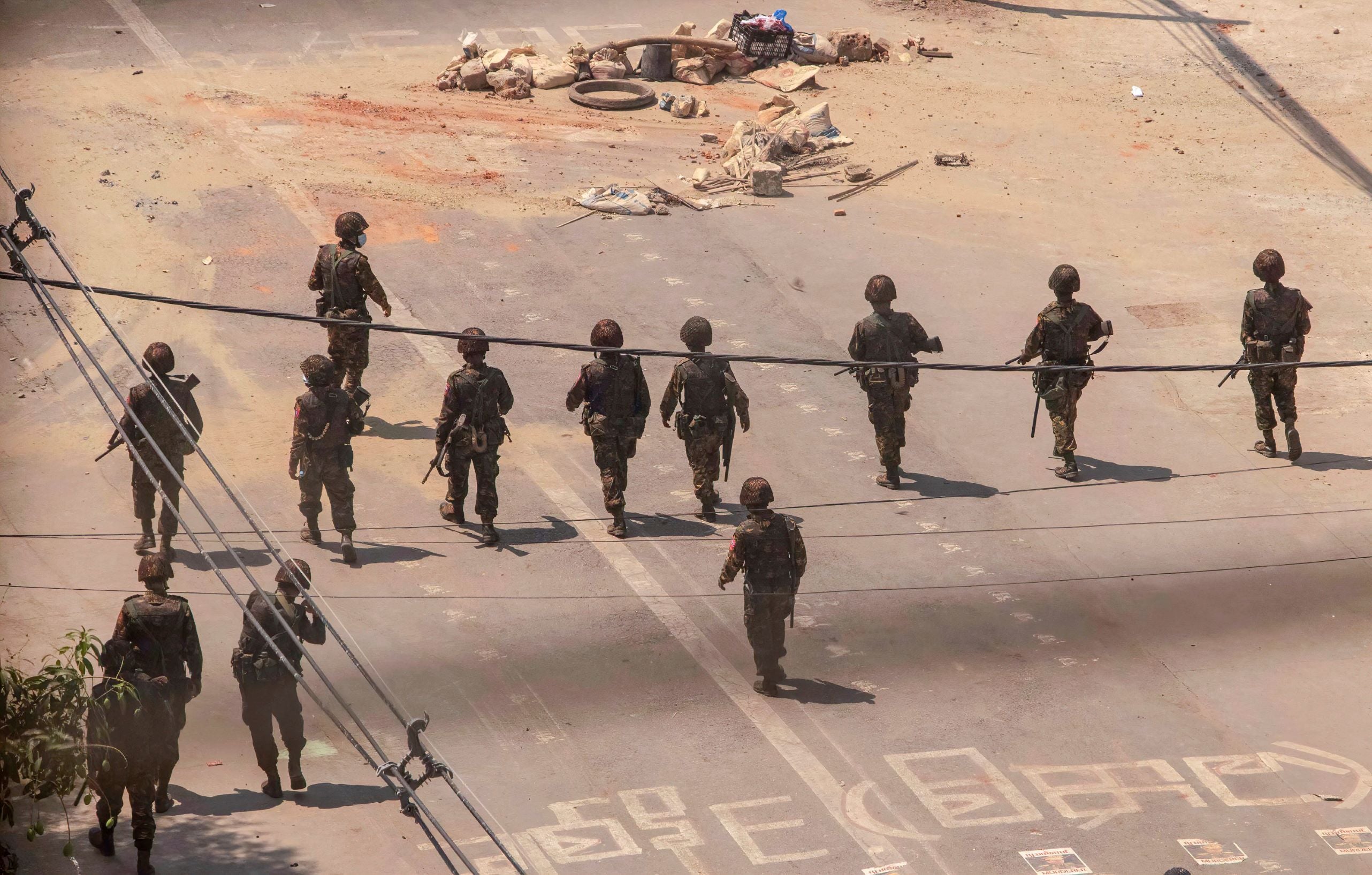 Myanmar military advance towards protesters during a demonstration against the military coup.
