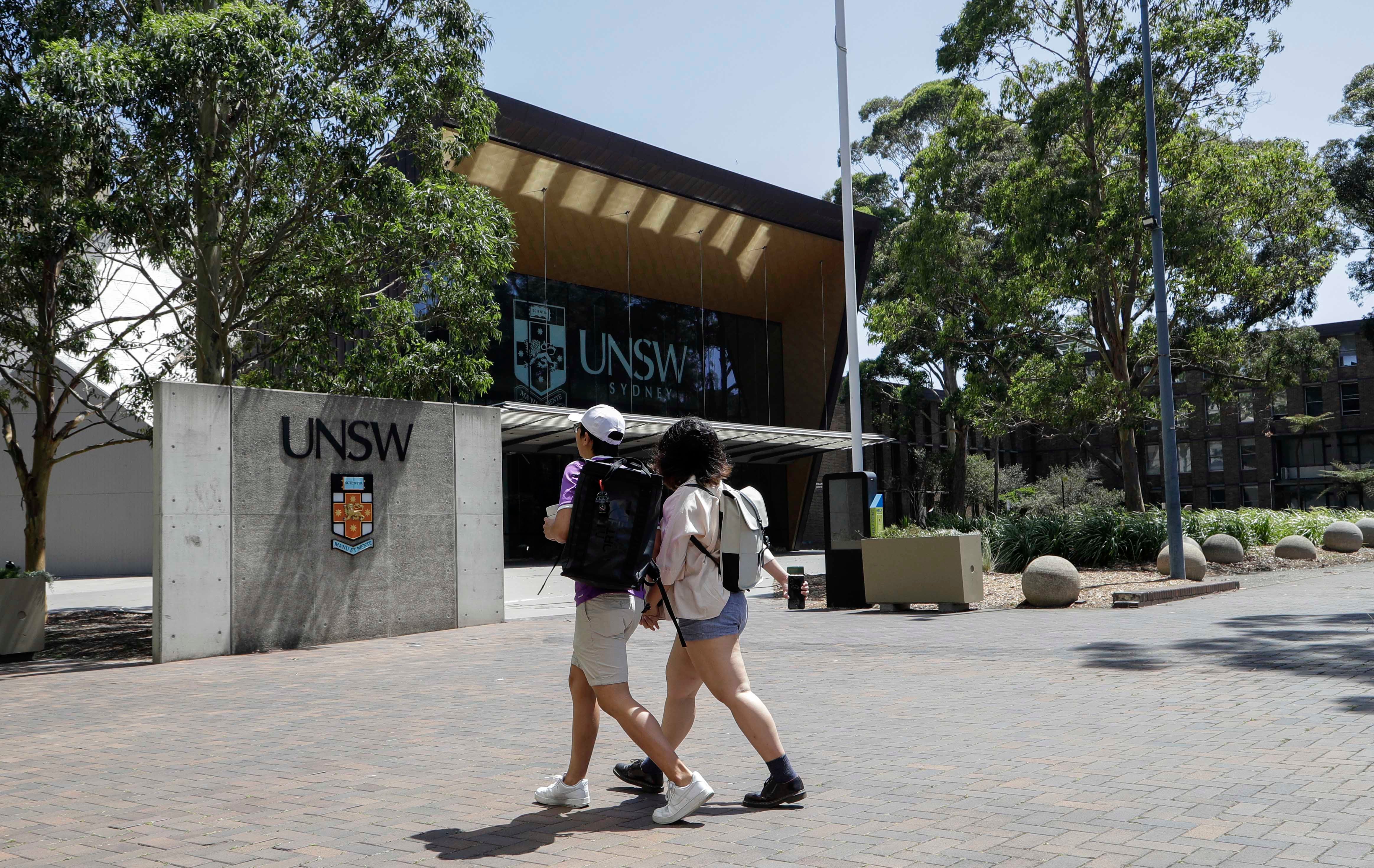 Two students walking on a university campus