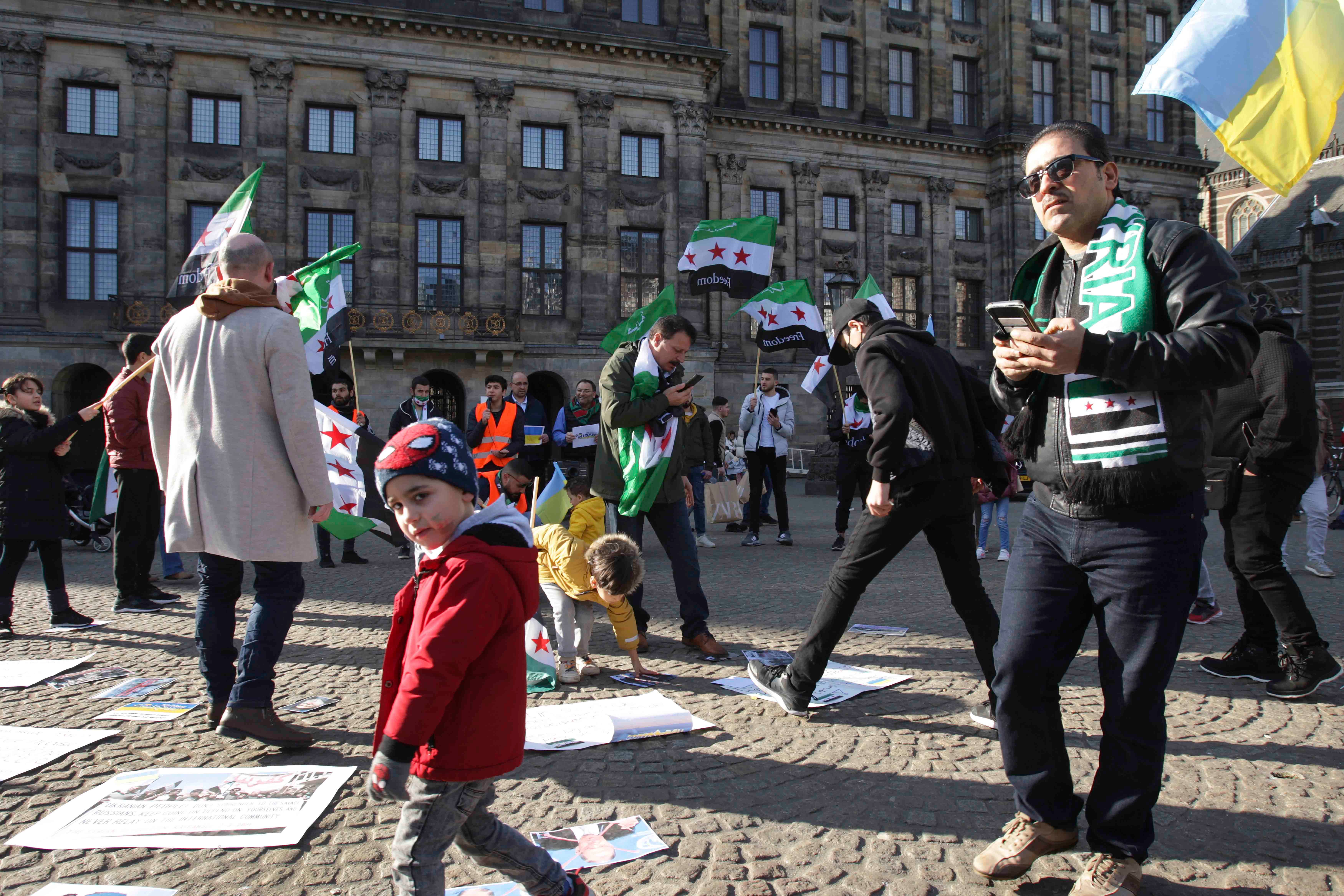 People display Syrian flags at a demonstration