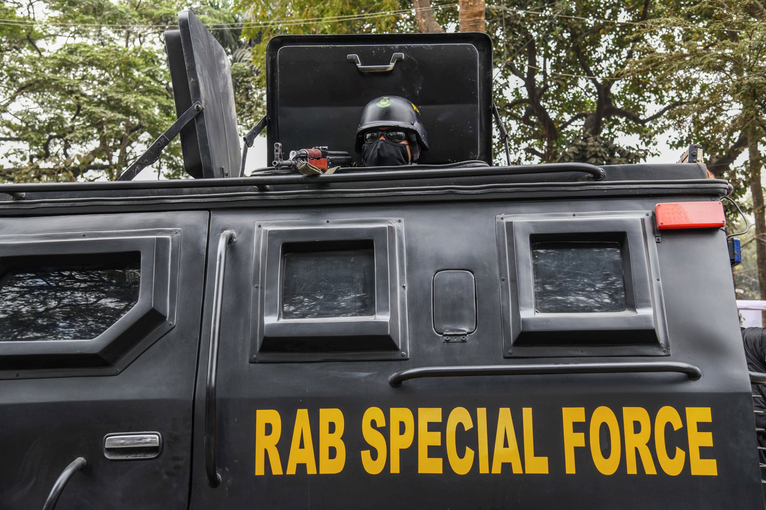 A Bangladeshi RAB (Rapid Action Battalion) member stands alert inside a truck at the Central Shaheed Minar in Dhaka, Bangladesh, February 20, 2021.