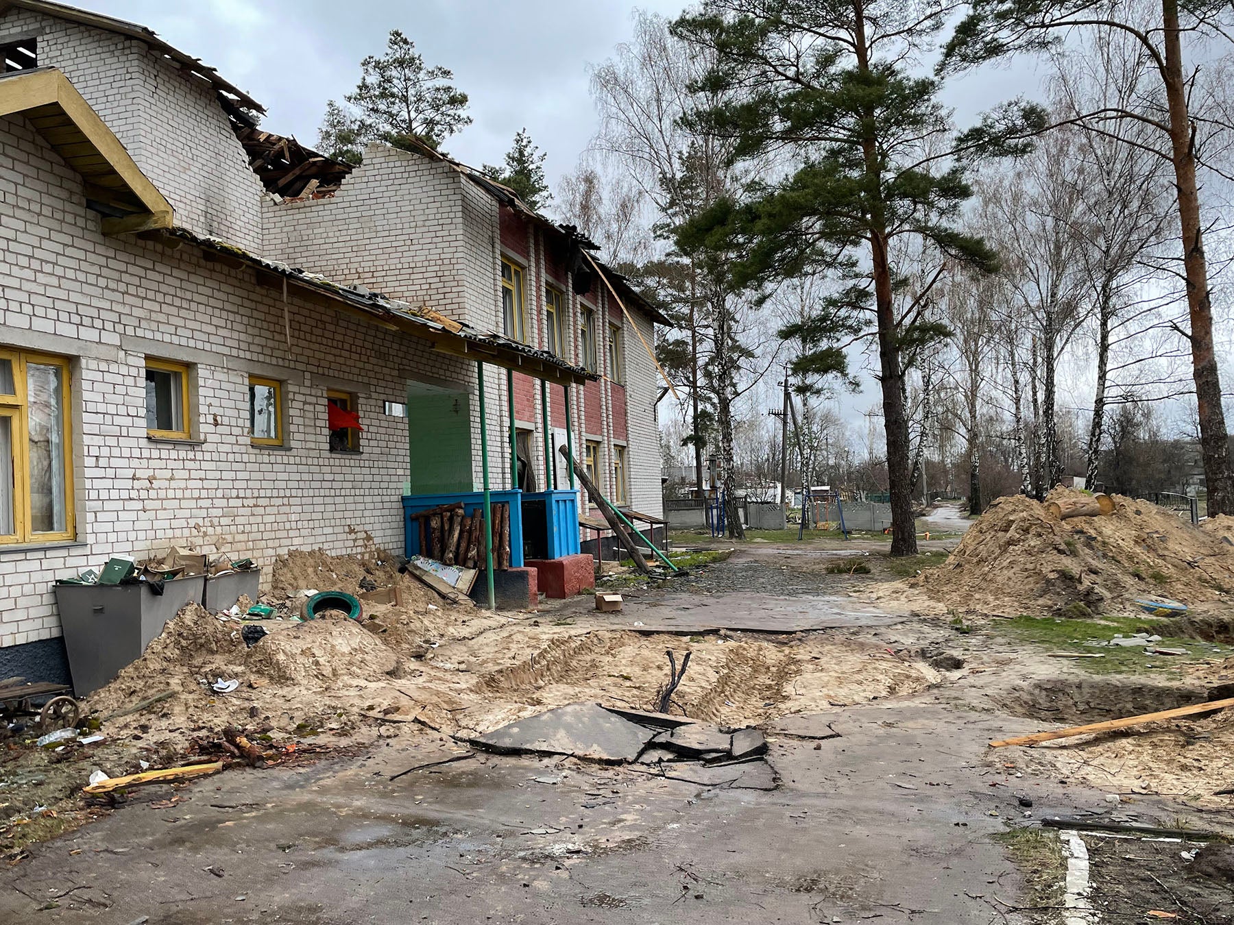 Holes dug in the Yahidne schoolyard, apparently from  the military use by the Russian forces, Yahidne, April 17, 2022.