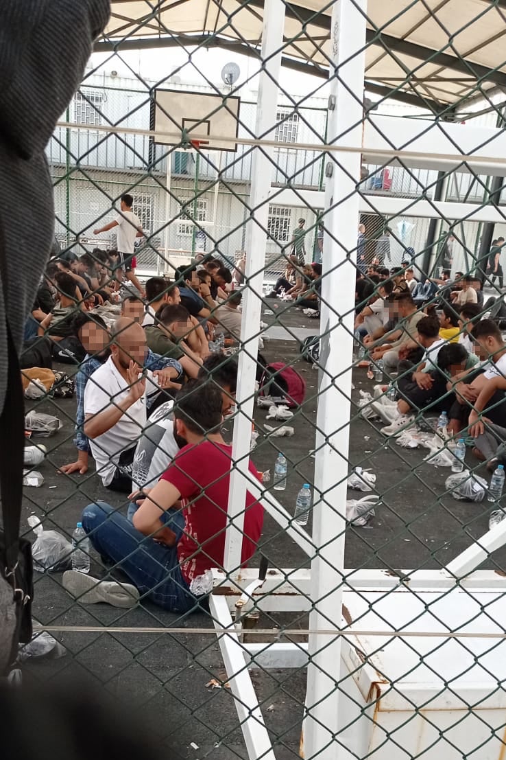 Migrants and refugees held in a basketball court for hours while waiting for a cell in Tuzla Removal Center in June 2022. © 2022 private