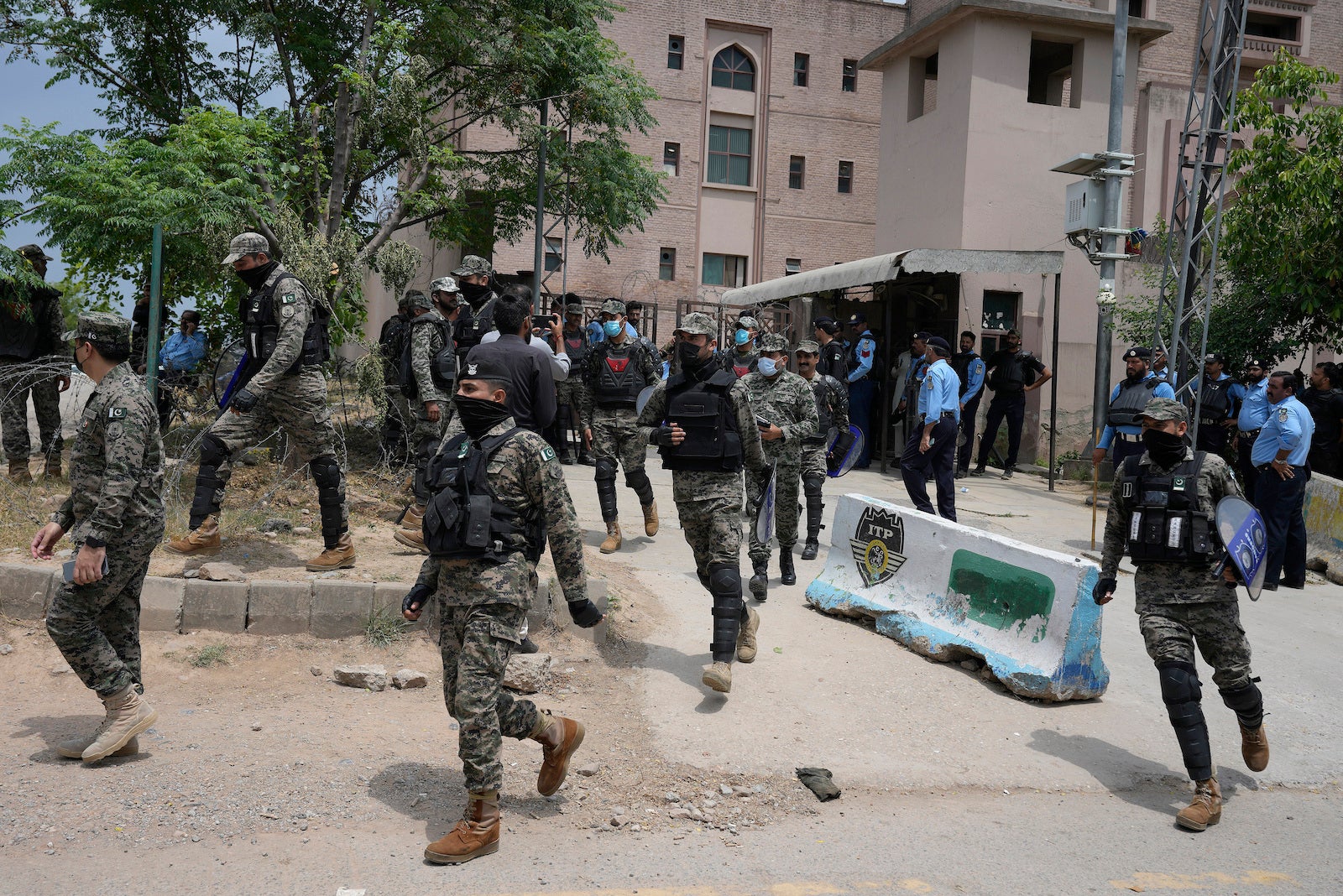 Paramilitary troops and police officers stand guard outside a court where Pakistan's former Prime Minister Imran Khan is scheduled to appear in Islamabad, Pakistan, May 23, 2023. 