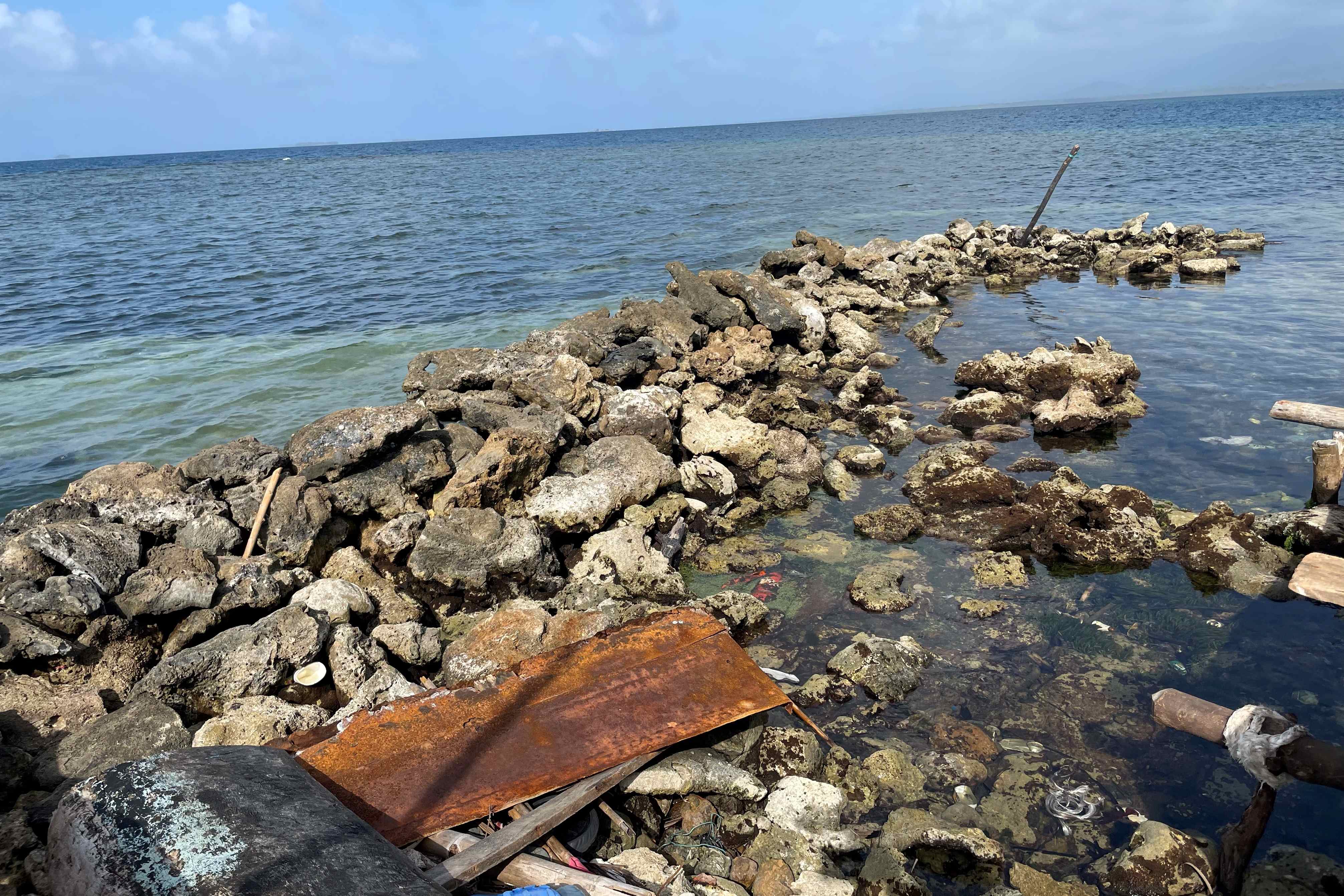 The practice of 'filling' with coral on a neighboring island.