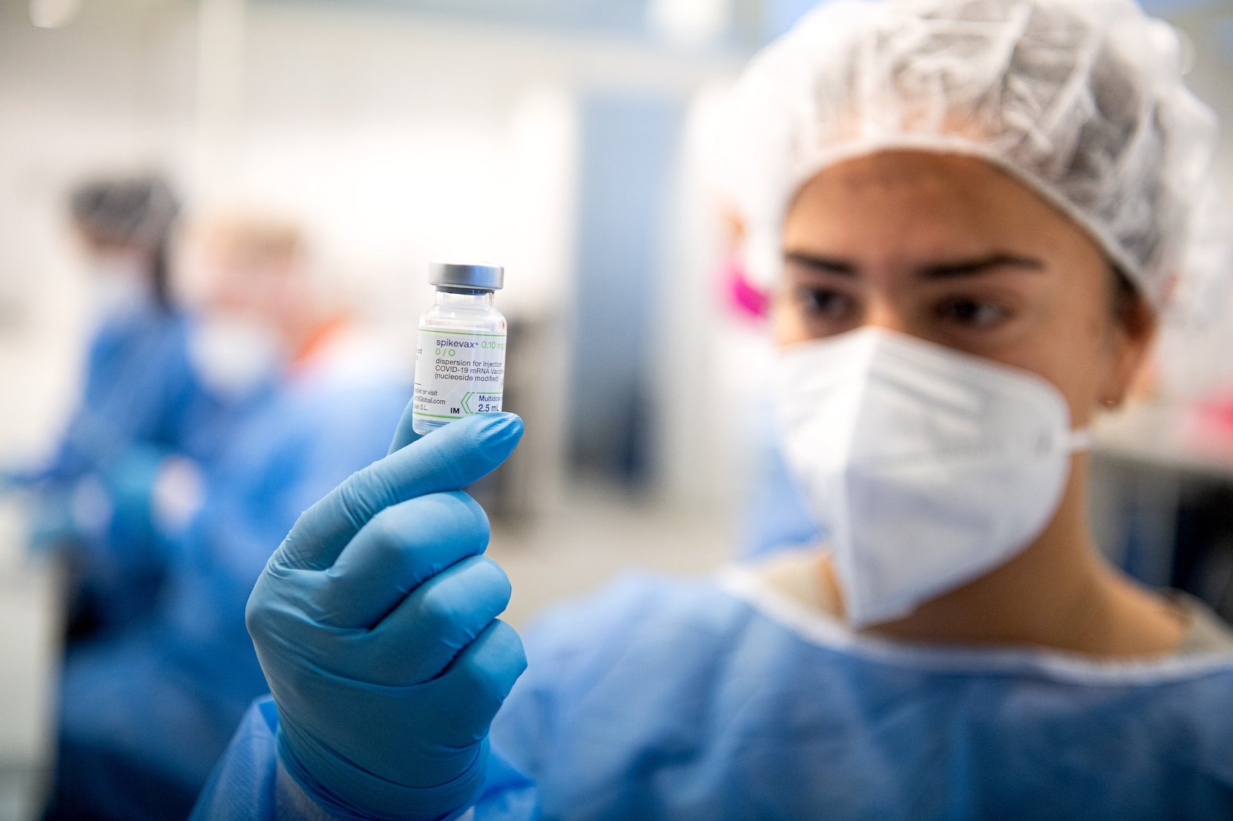 A staff member from the vaccination center at Brill holds a bottle of Moderna's Spikevax vaccine, Germany, September 13, 2022. 