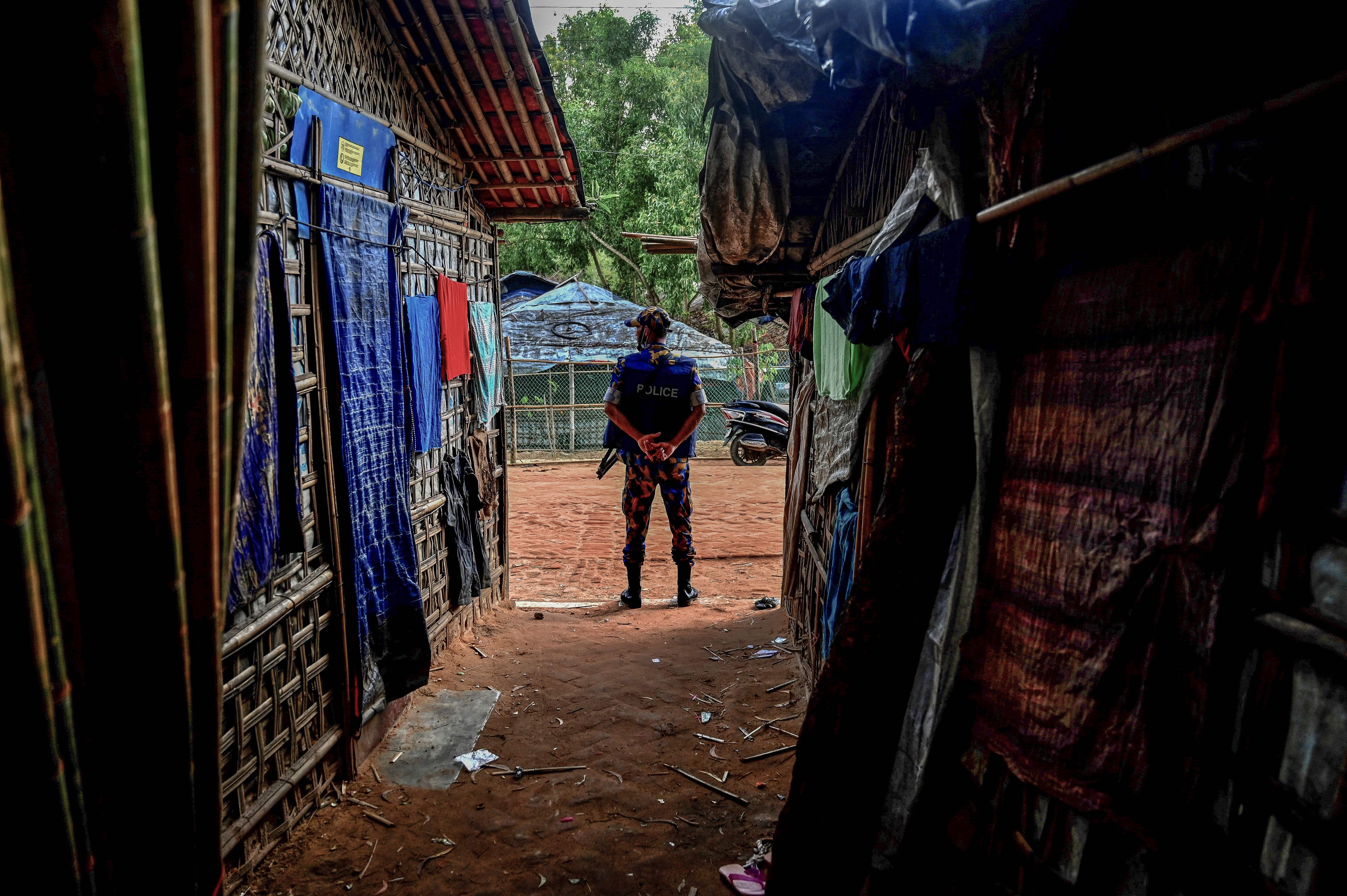 A member of the Armed Police Battalion stands guard at the Kutupalong refugee camp in Ukhia, Bangladesh, October 5, 2021. 