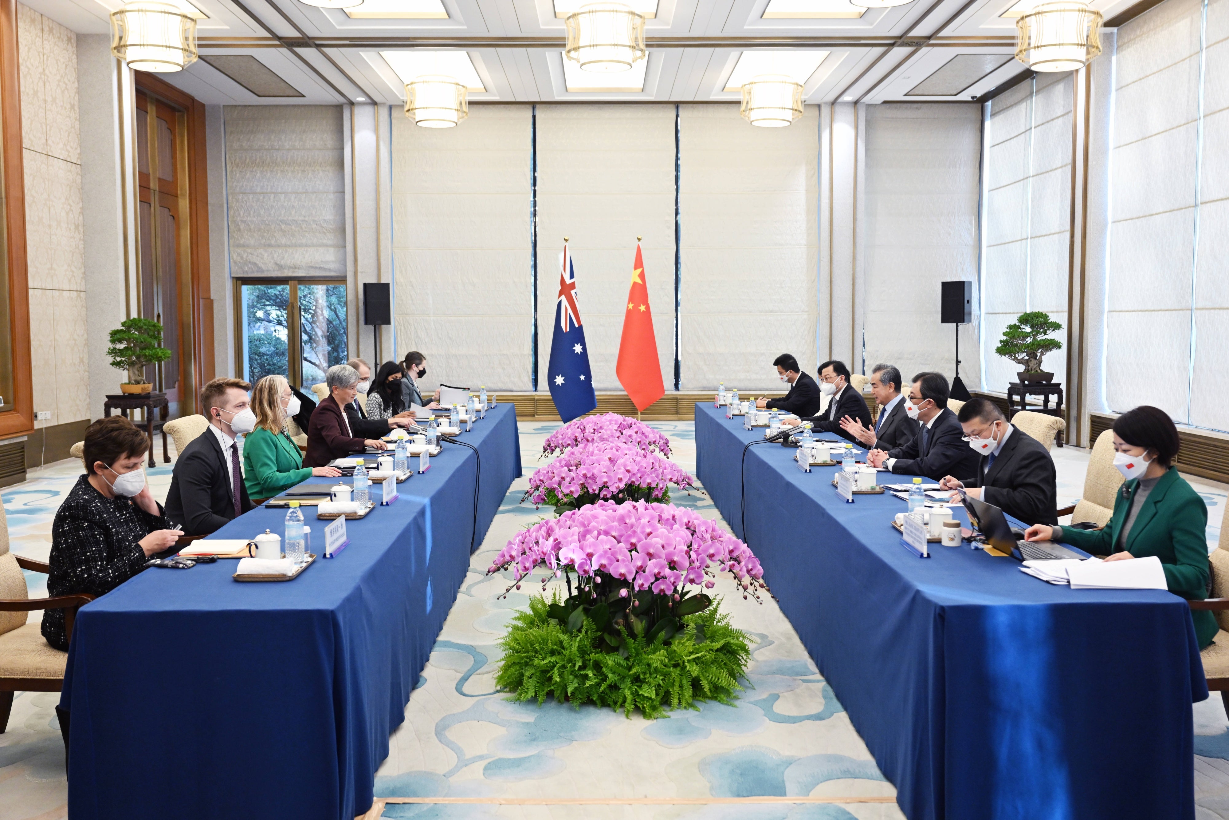 People seated around two tables opposite of each other