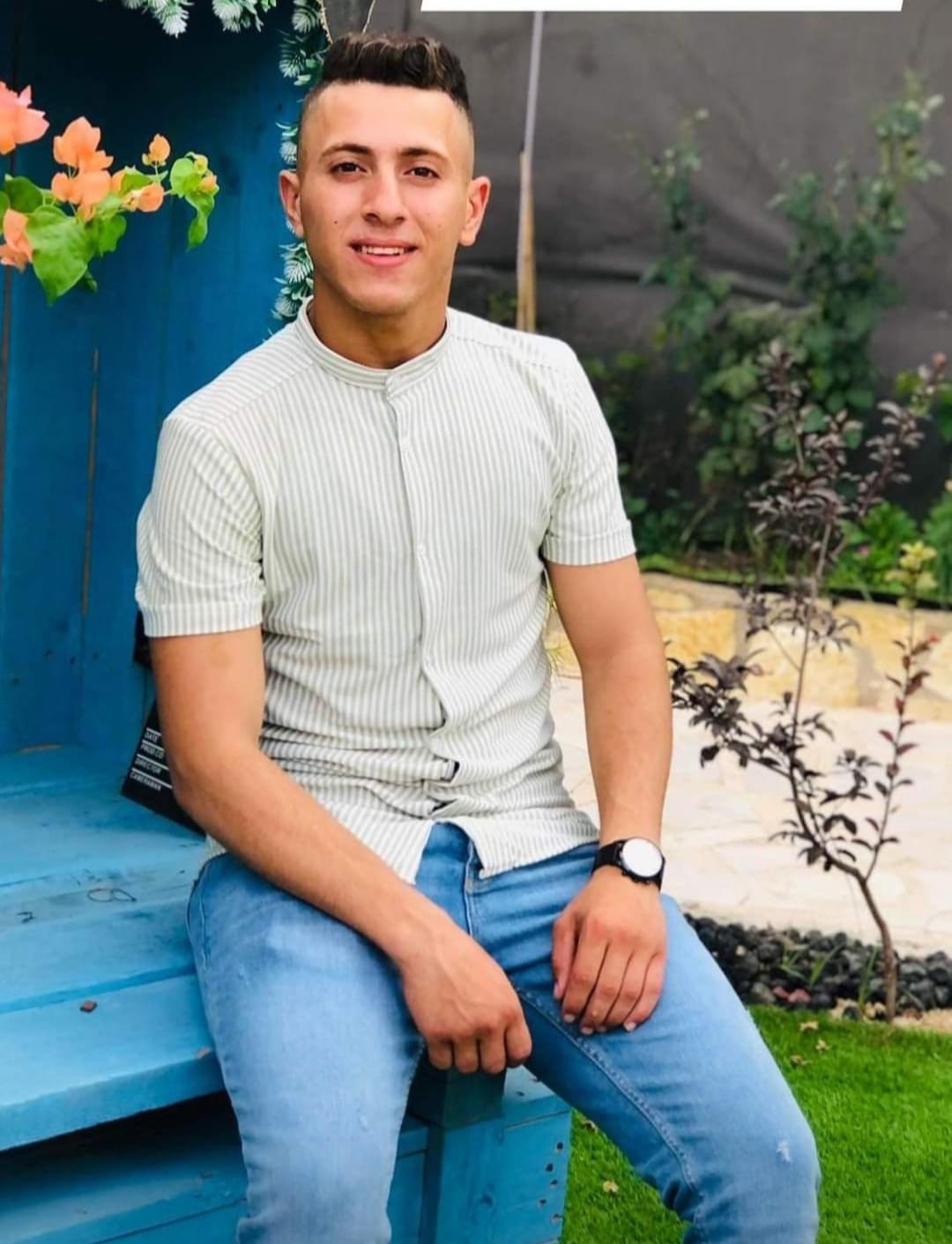 Rafiq Ghannam, 20, after he enrolled at Al-Quds Open University in Jenin, specializing in social work. The photo was taken in 2022, the same year he was killed by Israeli forces.