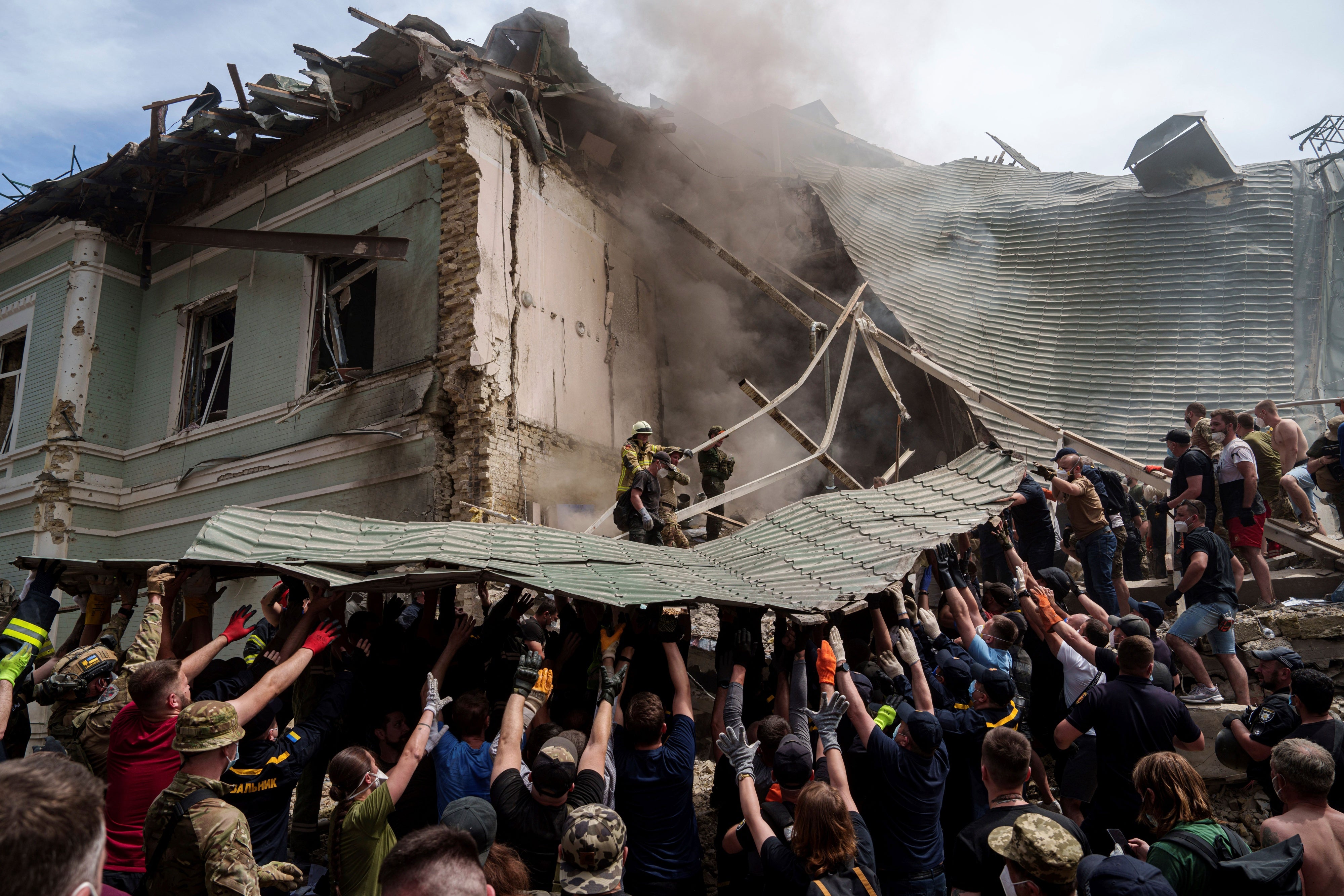 Des membres des services d'urgence ukrainiens retiraient une partie de la toiture de l'Hôpital Okhmatdy pour enfants à Kiev, le 8 juillet 2024, suite à une frappe d’un missile russe ayant partiellement détruit cet hôpital.