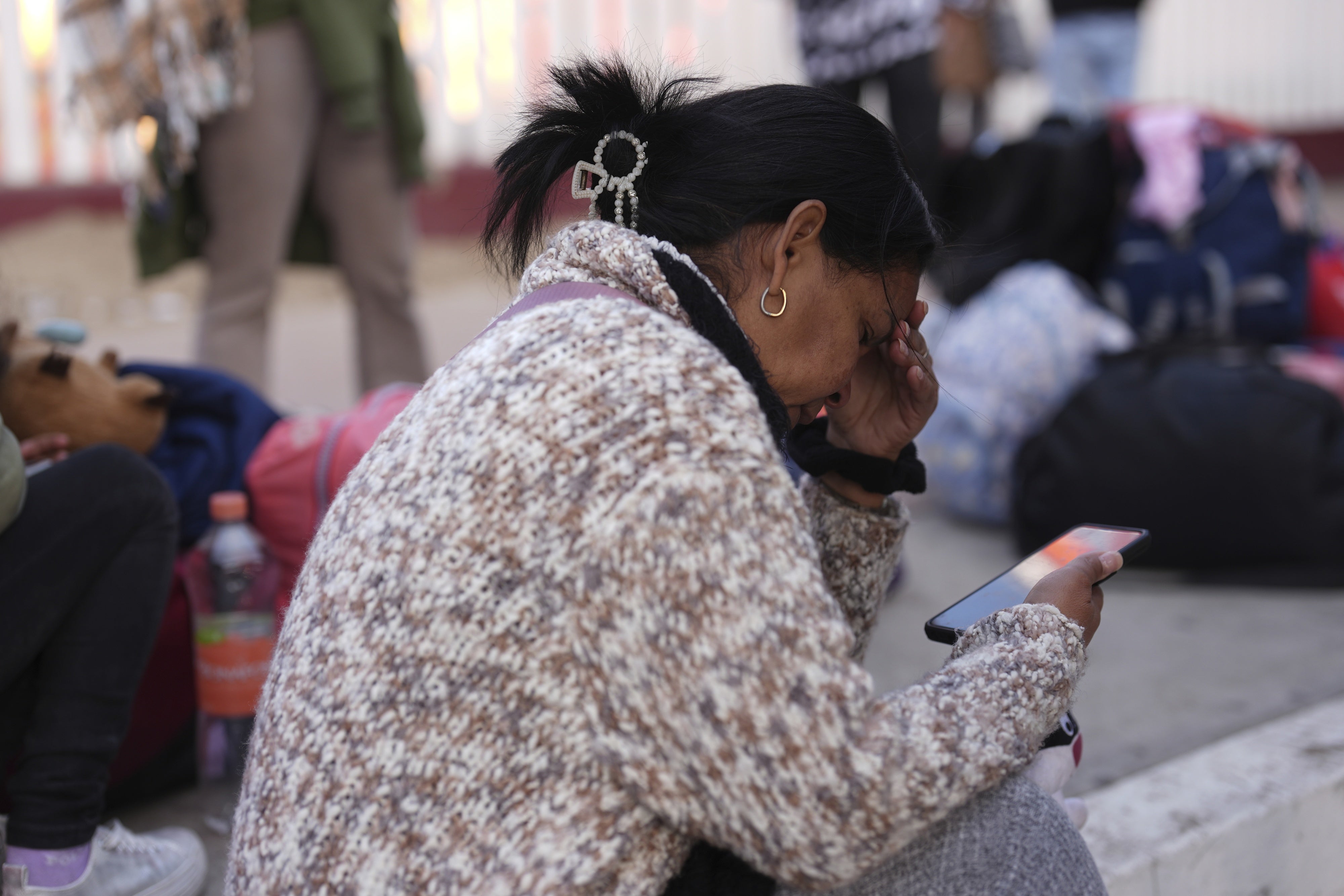 Maria Mercado, who is from Colombia but arrived from Ecuador, reacts as she sees that her appointment was canceled on the US Customs and Border Protection (CBP) One app