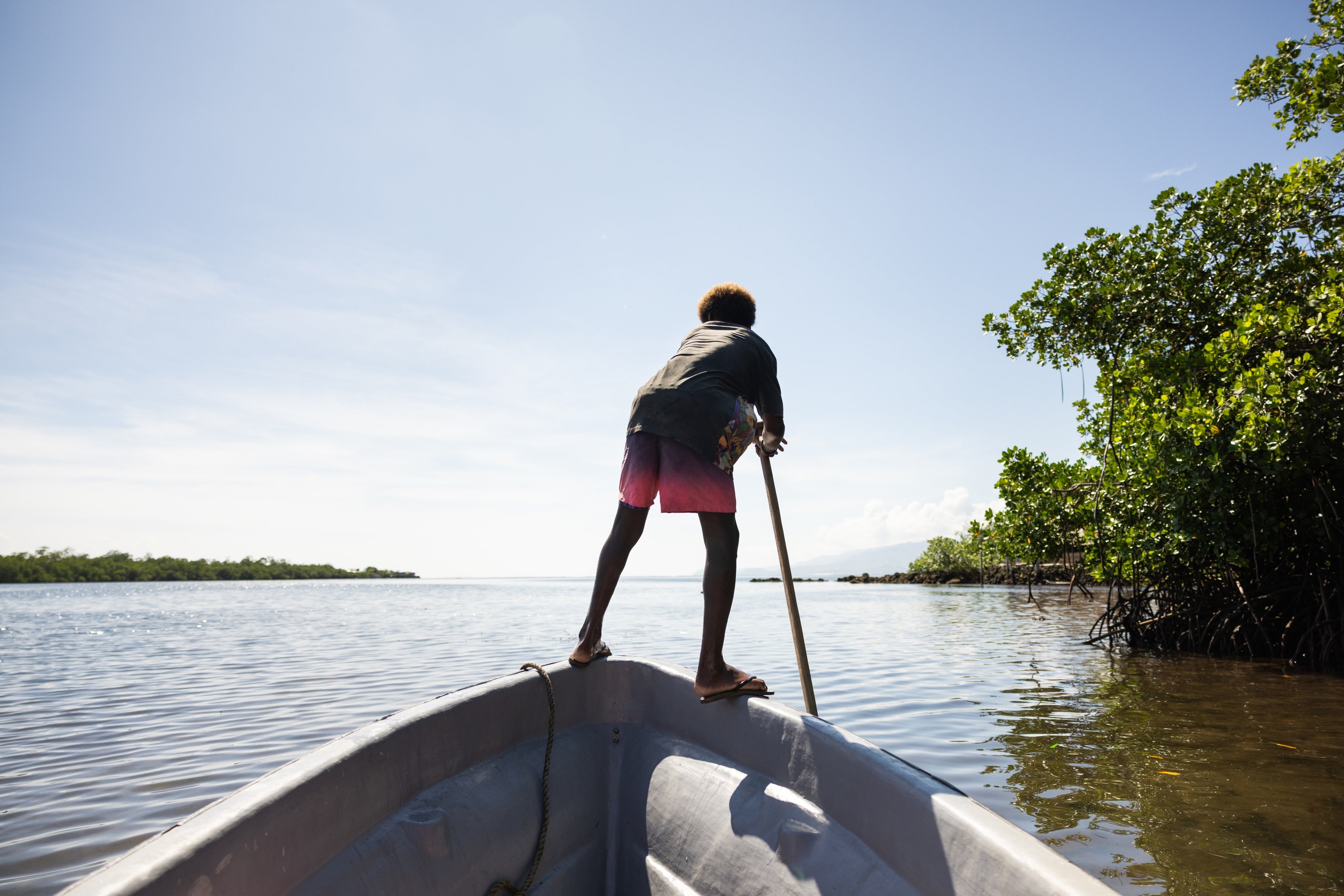 Boy on a boat in the mangroves near the village of Walande.