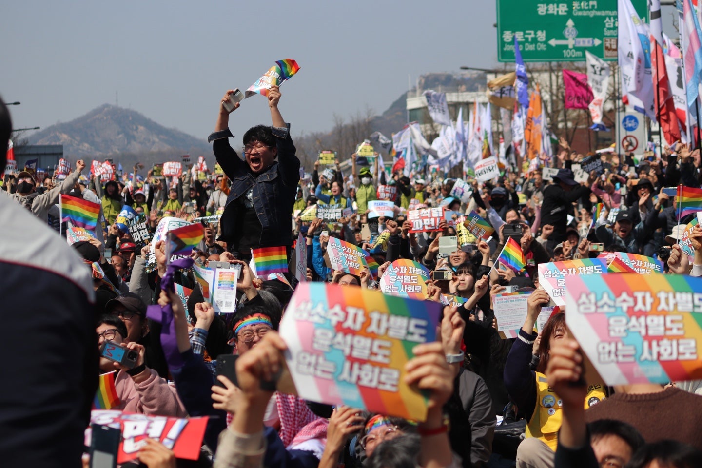 People celebrate after the Constitutional Court's ruling to remove President Yoon from office, near Anguk Station, Seoul, South Korea, on April 4, 2025. 