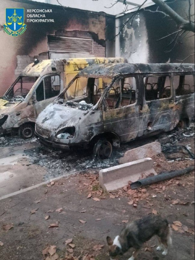 Photograph of two destroyed ambulances parked on the Oncology Center grounds. 