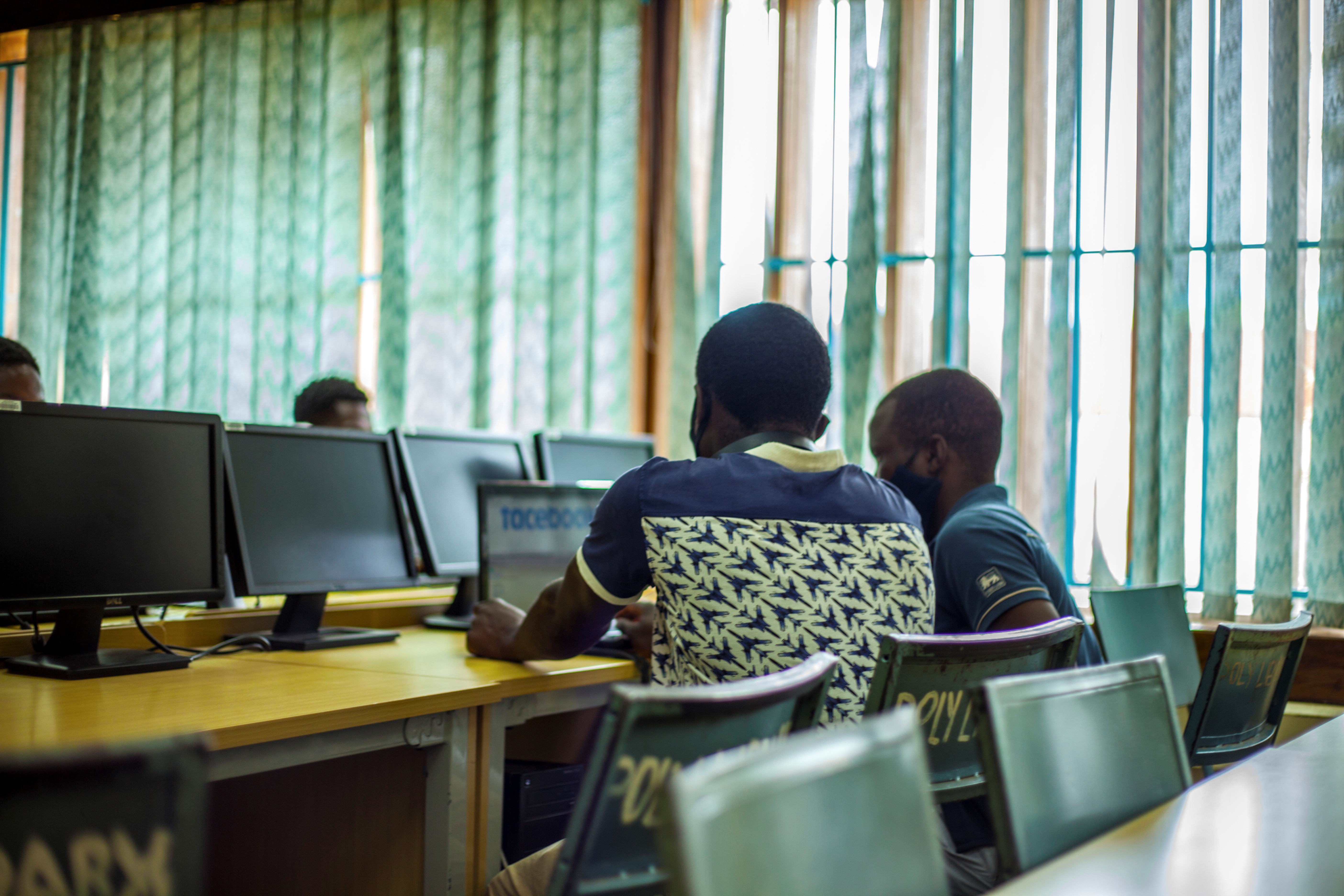Students following up a lesson through a laptop in Blantyre, Malawi, January 13, 2021.