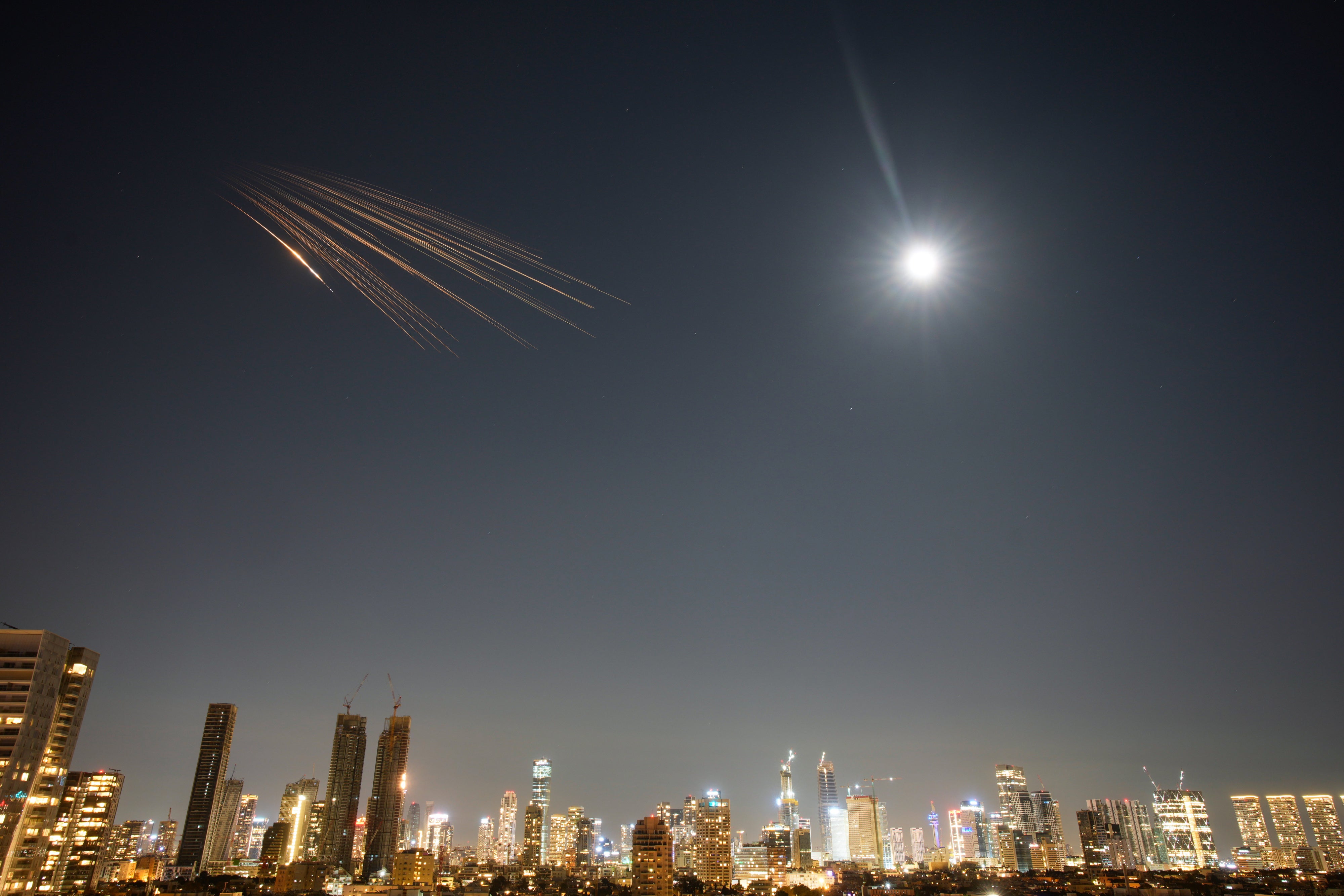 Missiles launched from Iran carrying suspected cluster munitions streak across the sky over central Israel, March 5, 2026.