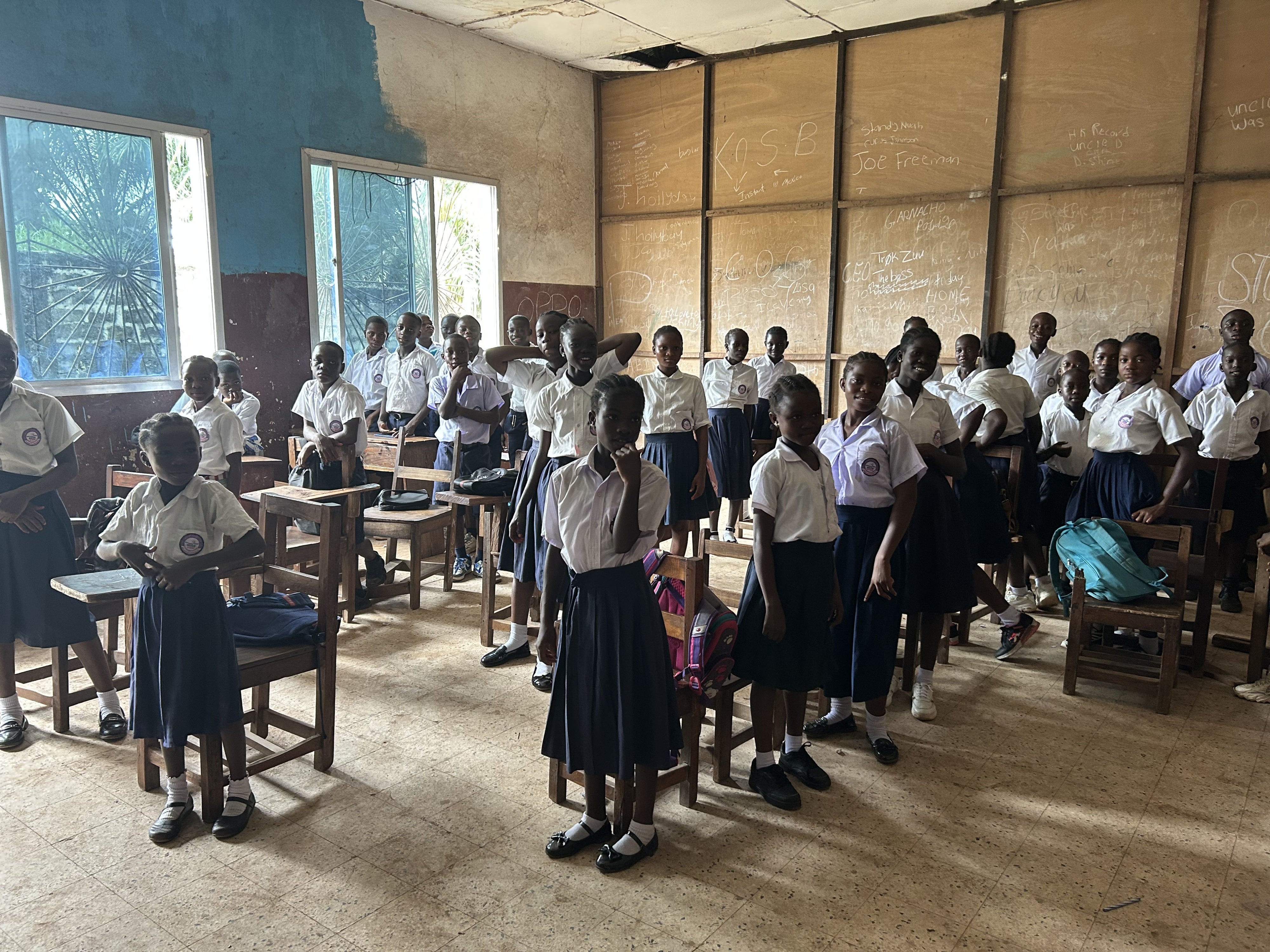 Students standing at their desks in a classroom