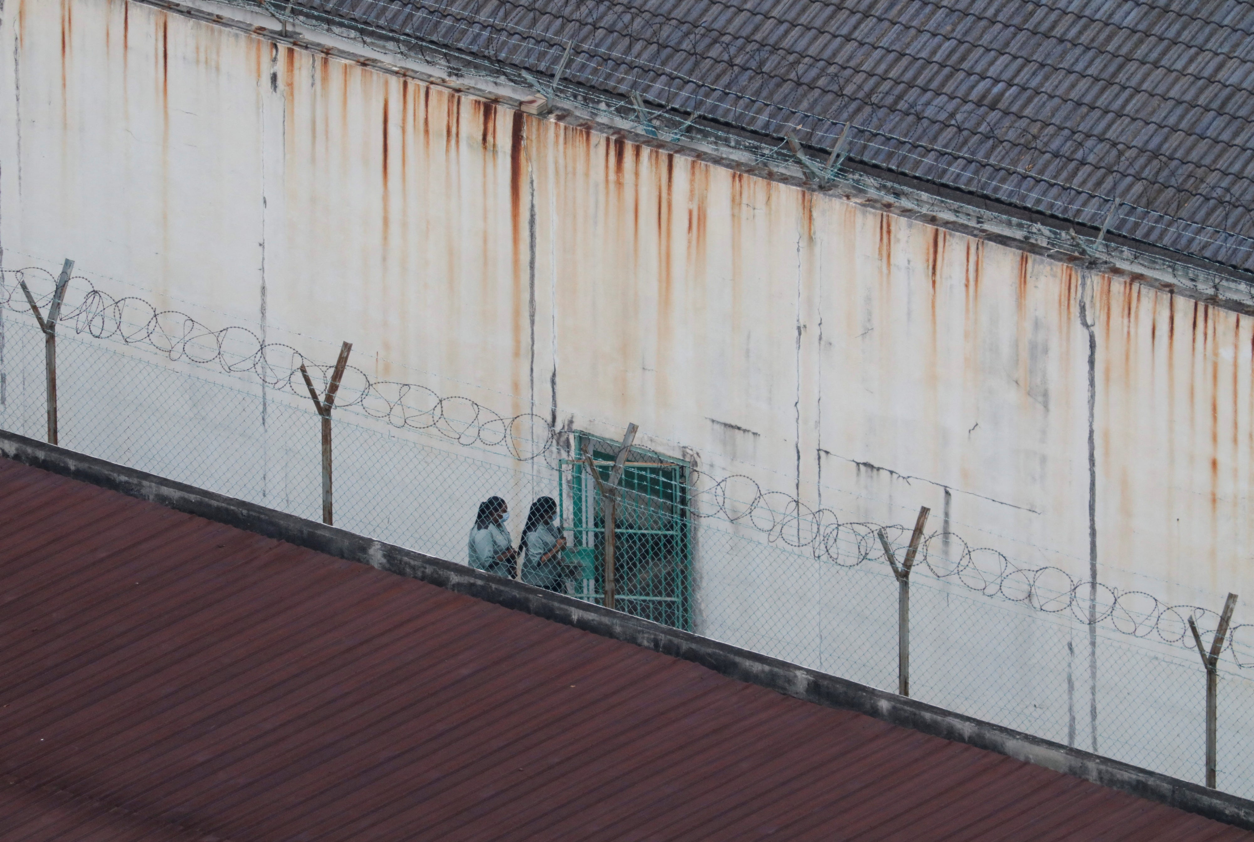 People walk inside an immigration detention center in Kuala Lumpur, Malaysia, February 23, 2023.