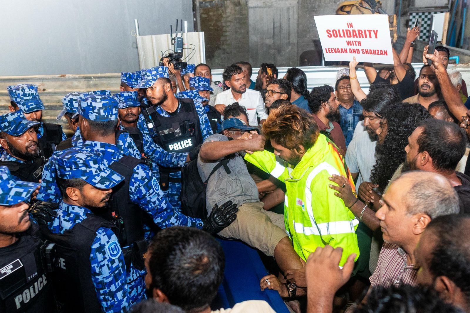 Police block protesters during a demonstration against the jailing of two journalists in the Maldives capital of Malé, on May 13, 2026. 
