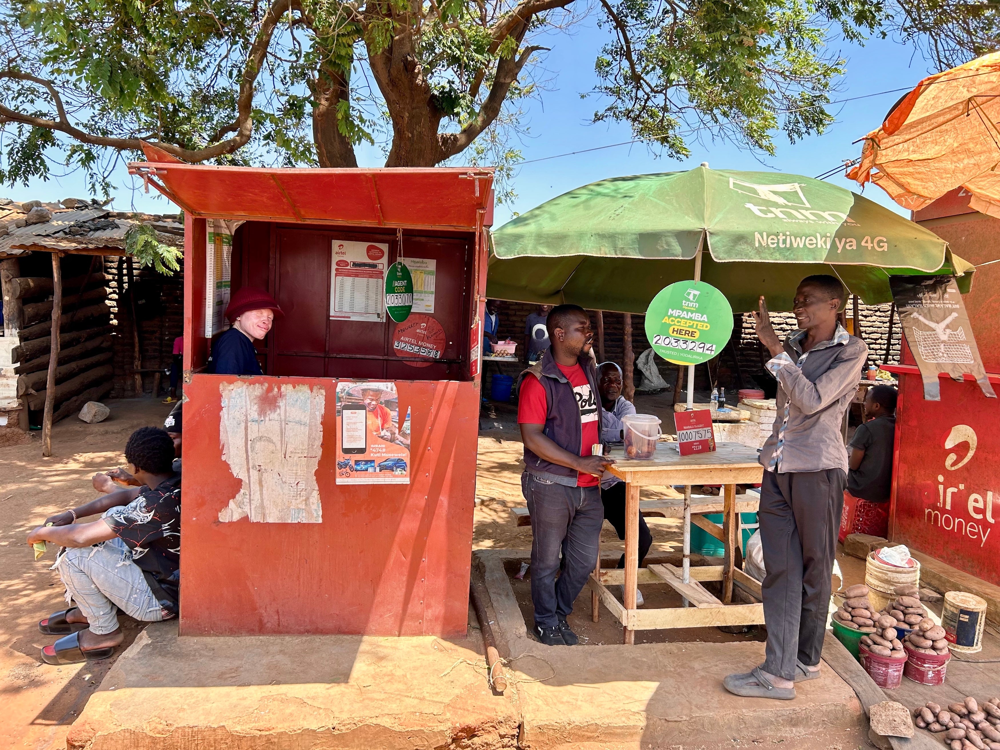 Maureen Kamatu, 28, has been self-employed at a mobile money cash-transfer booth in Lilongwe, Malawi. 