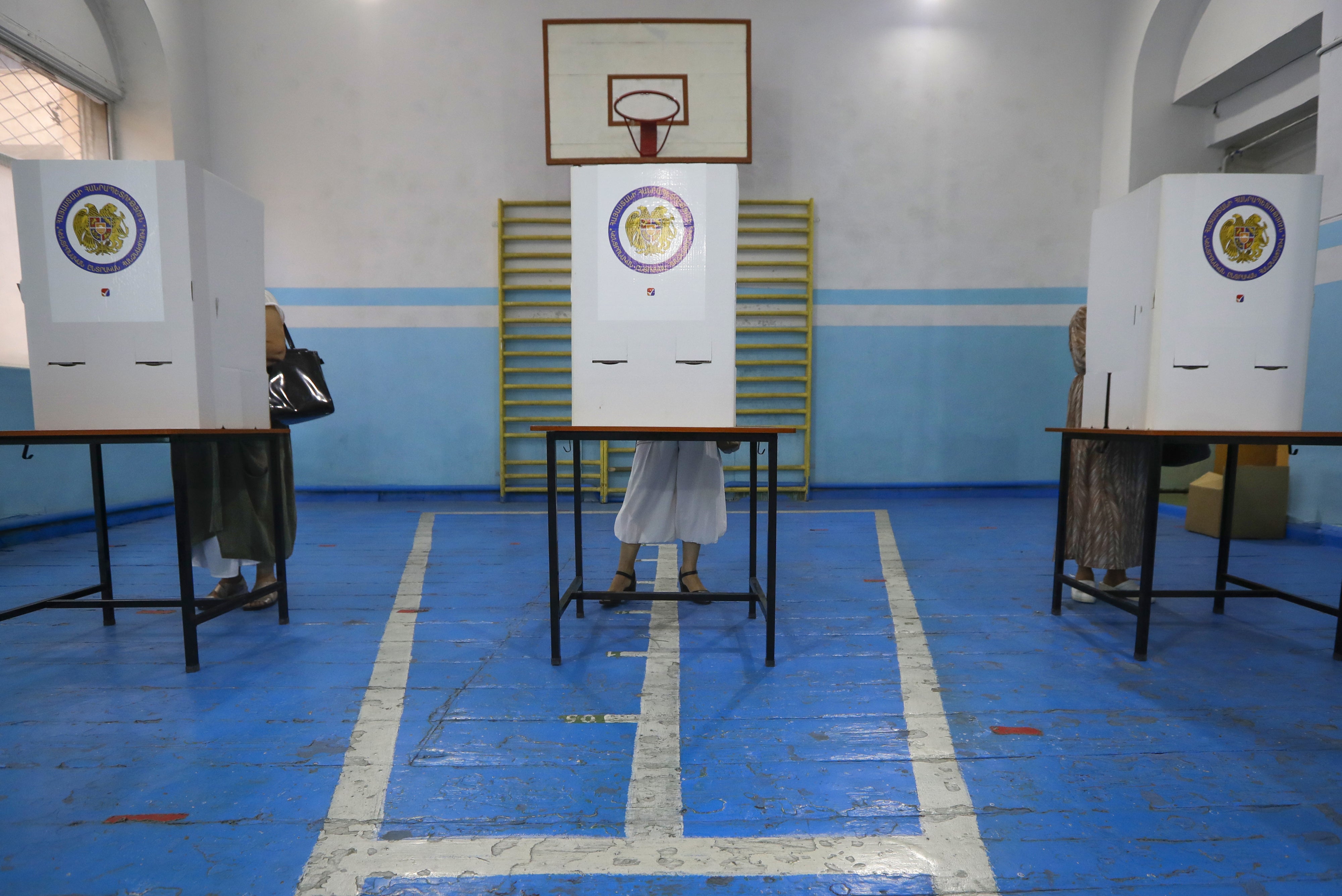 People at a polling station during a parliamentary election in Yerevan, Armenia, June 20, 2021.