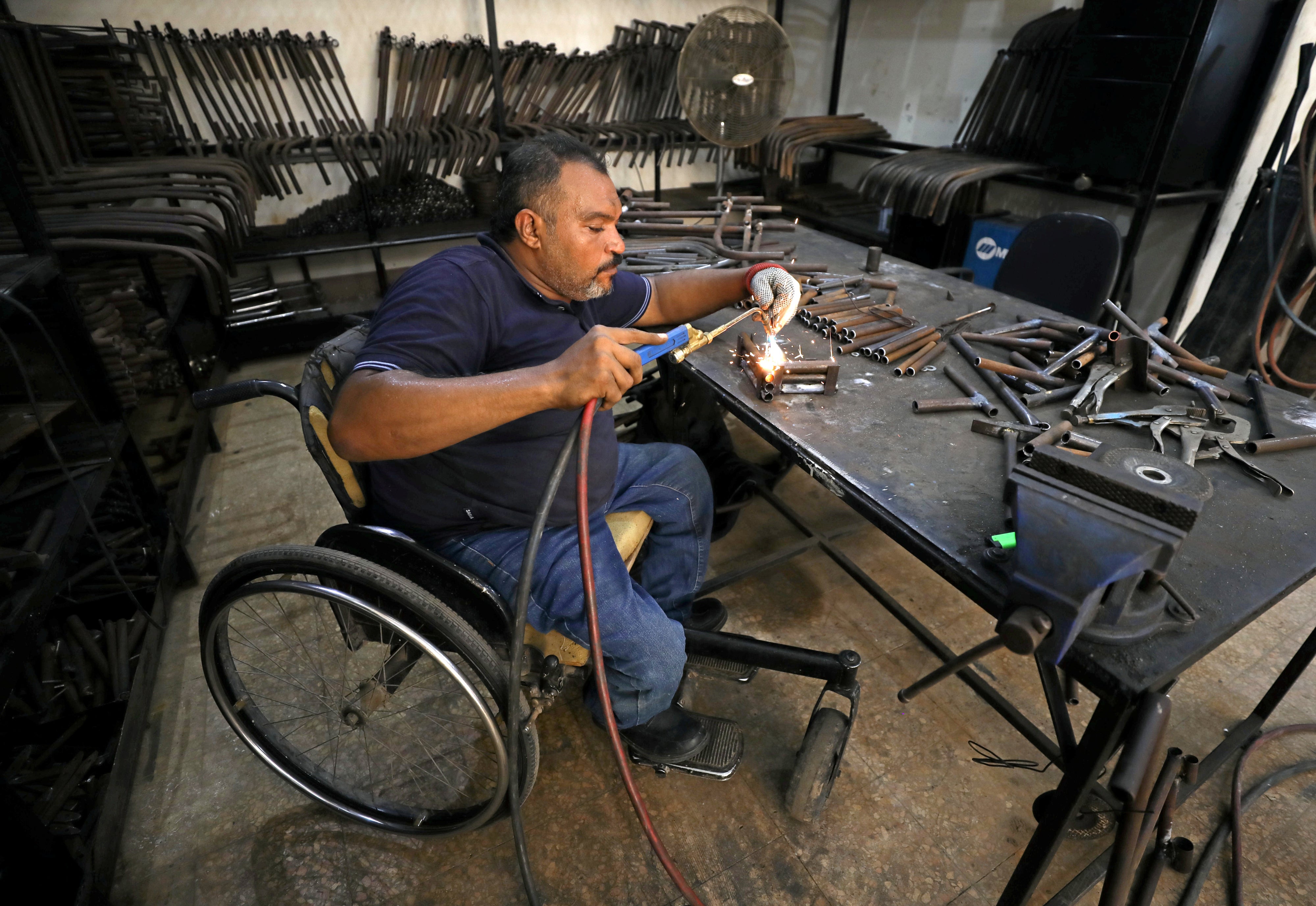 A man with a physical disability builds mobility products for underserved communities in Cairo, Egypt, August 8, 2017.
