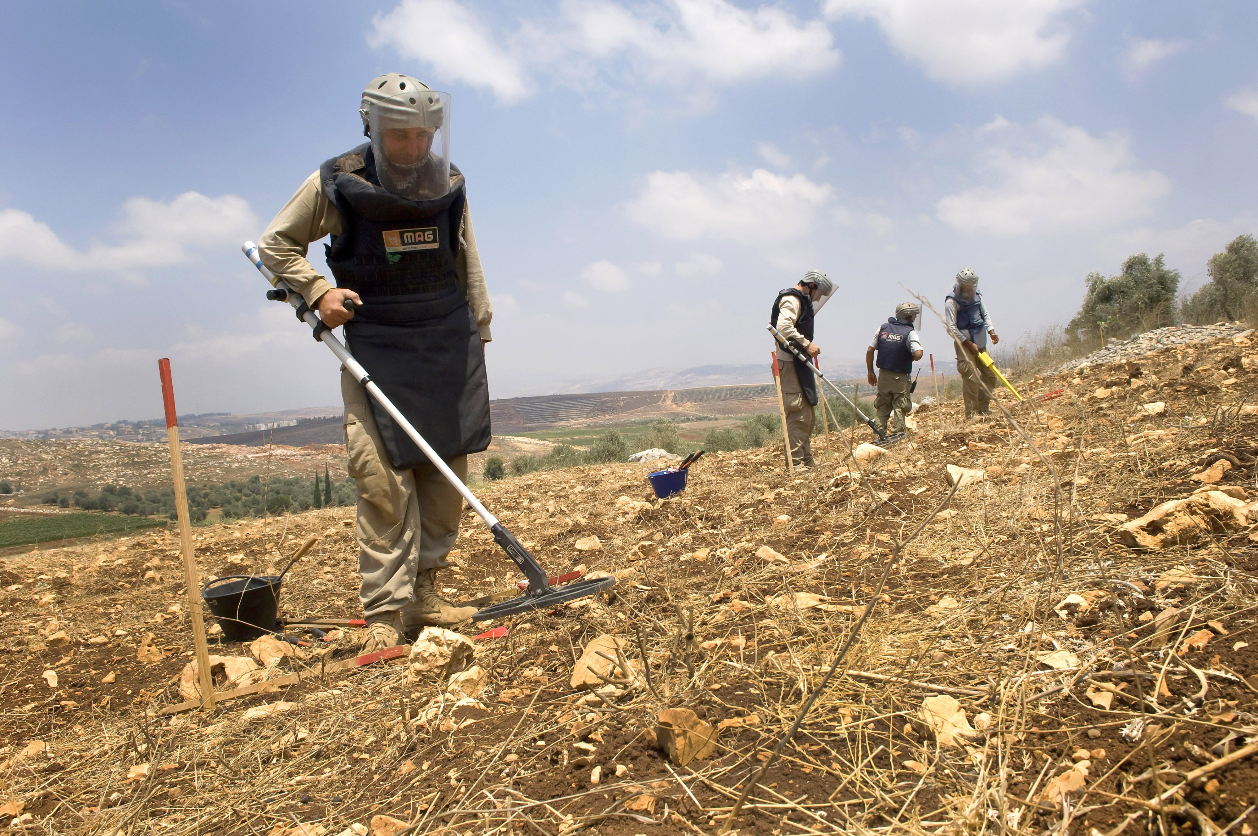 A team from the Mines Advisory Group (MAG) clearing unexploded cluster munitions on farmland in southern Lebanon, November 10, 2020. 