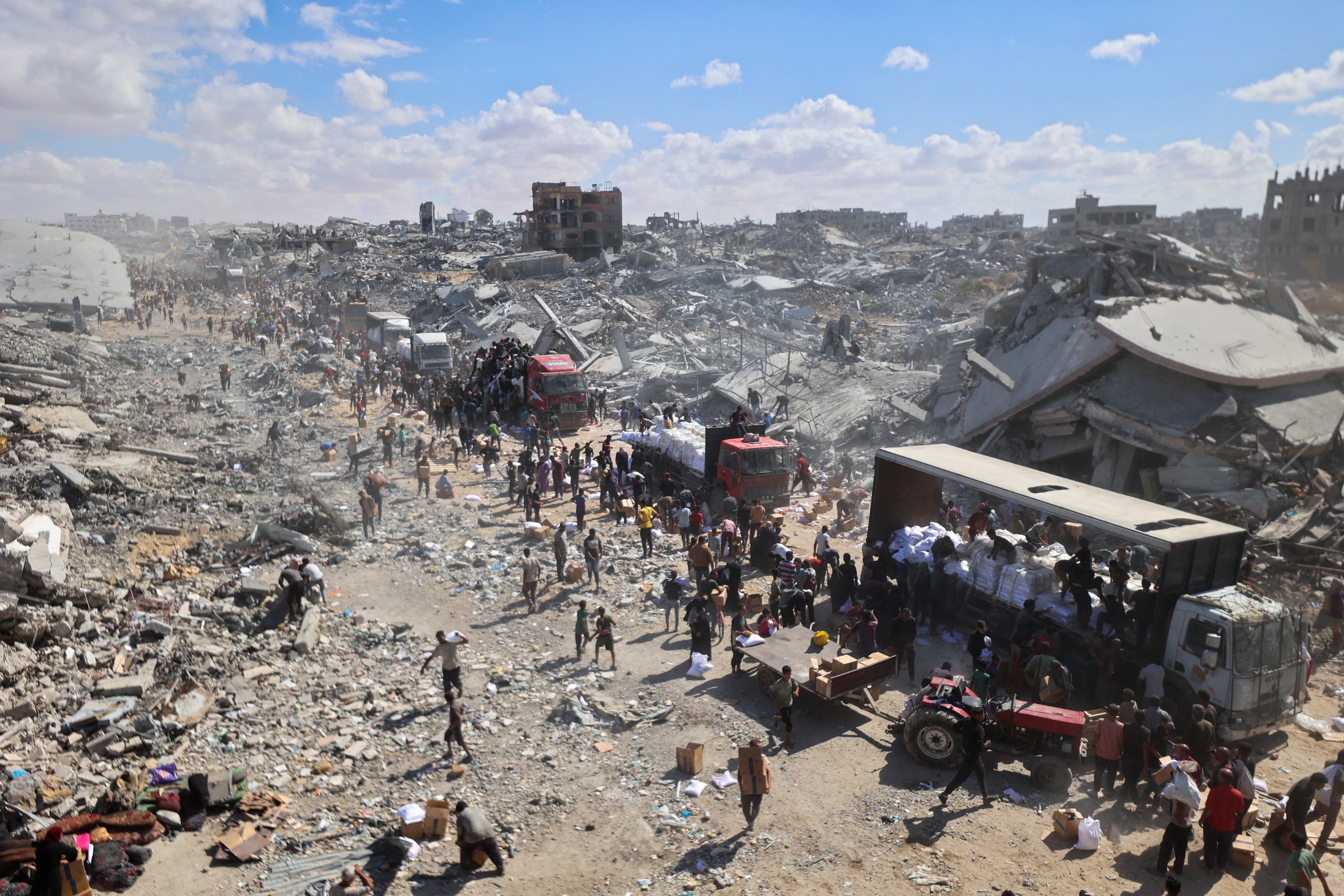 Aid trucks enter the Kerem Abu Salem crossing in Khan Younis, Gaza, October 12, 2025.