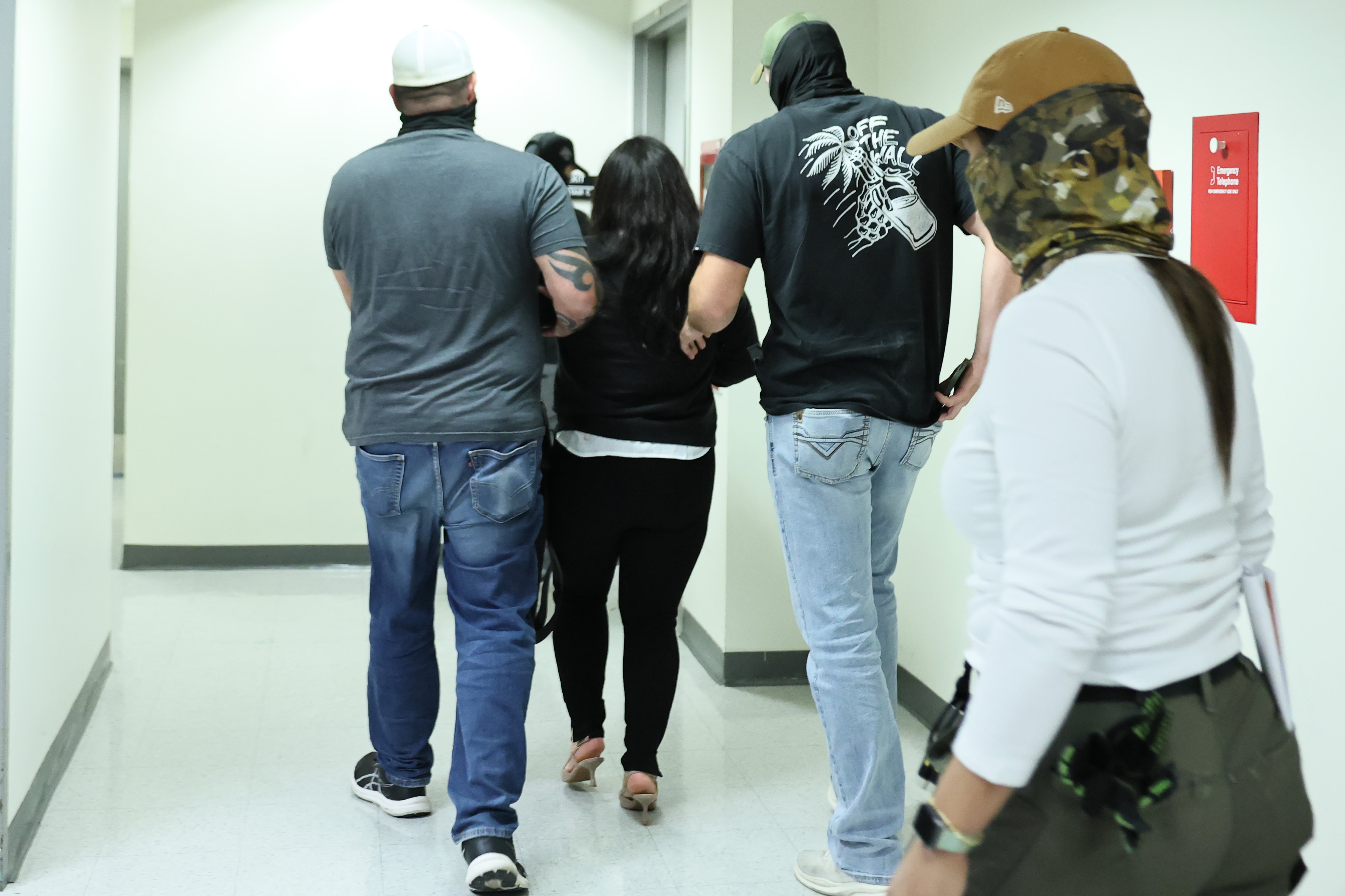A woman is detained by US federal agents after exiting a court hearing in immigration court at the Jacob K. Javits Federal Building in New York City, on September 3, 2025.