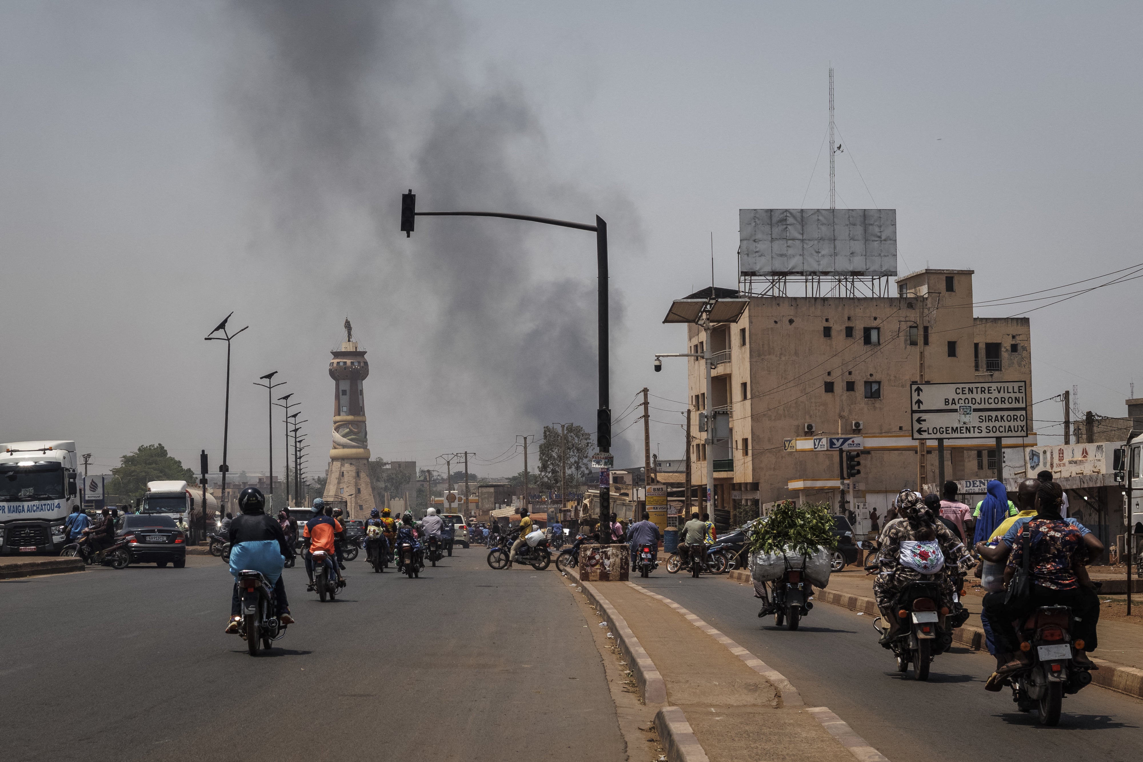 A column of black smoke rises above buildings in Bamako on April 26, 2026.
