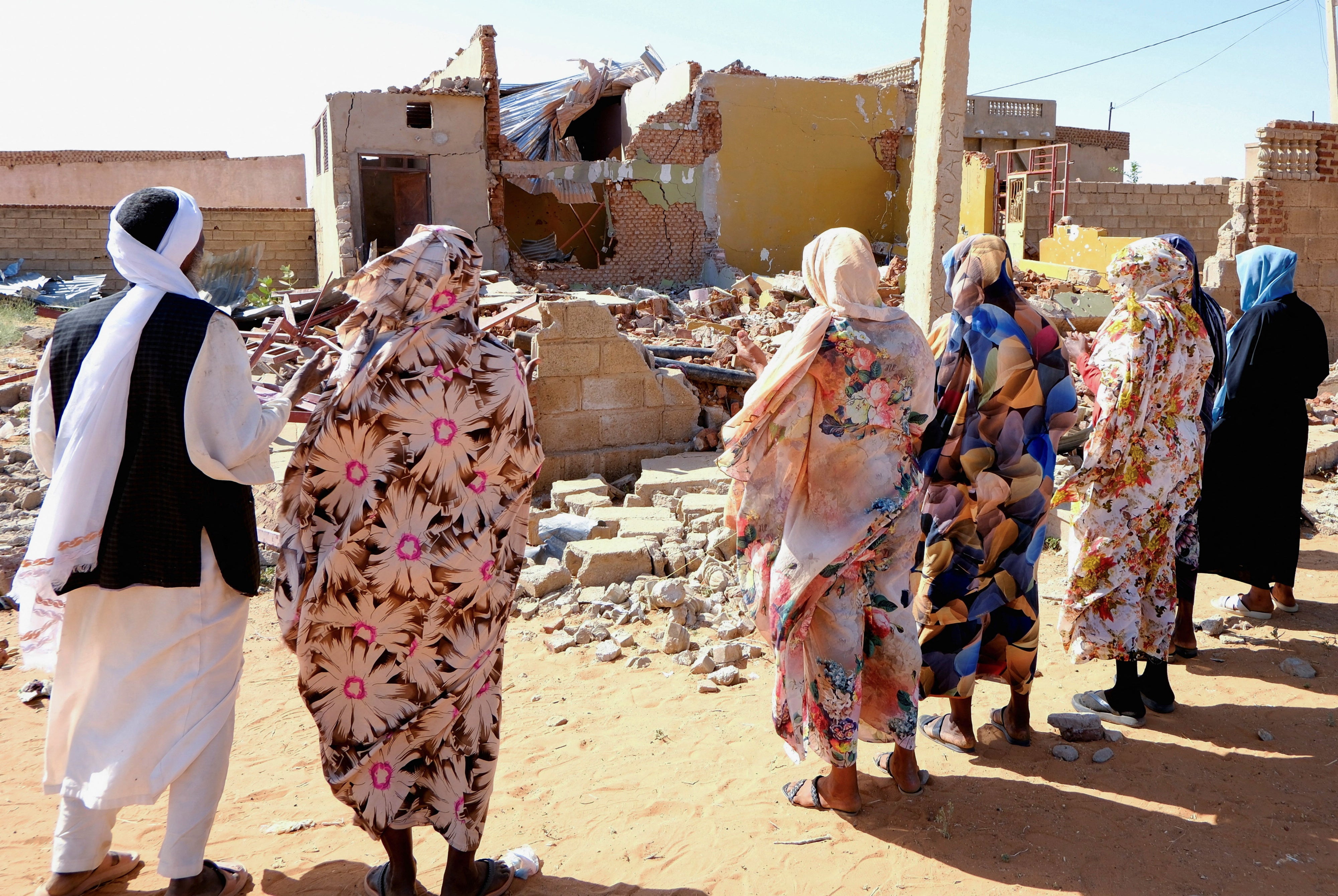 People pray for the victims of a drone strike in El Obeid, North Kordofan State, Sudan, January 12, 2026.