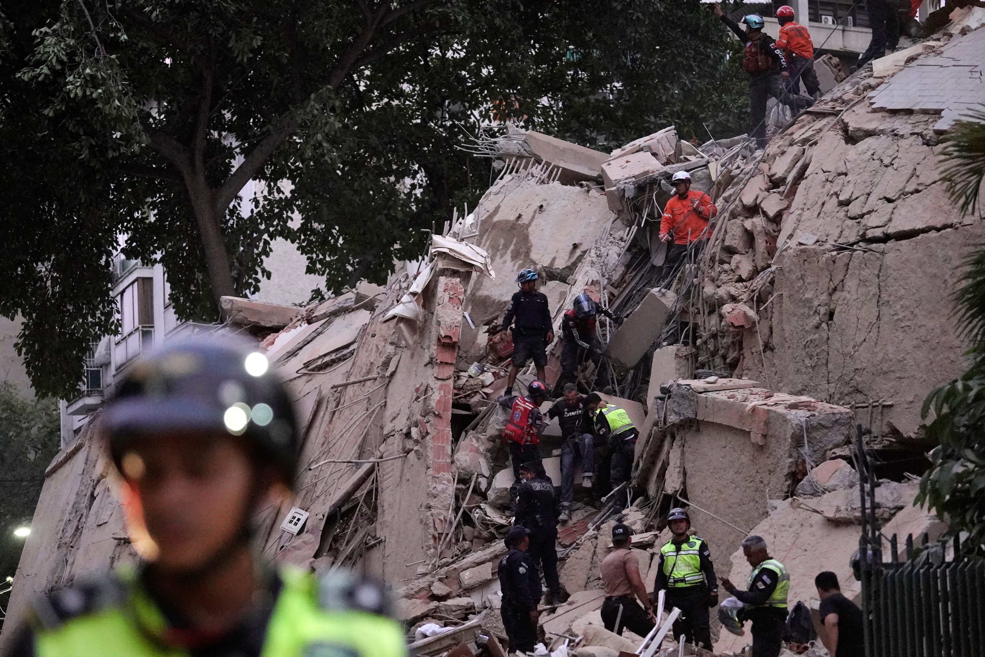 Rescue workers evacuate an injured person from a collapsed building following an earthquake in Caracas, Venezuela, on June 24, 2026.