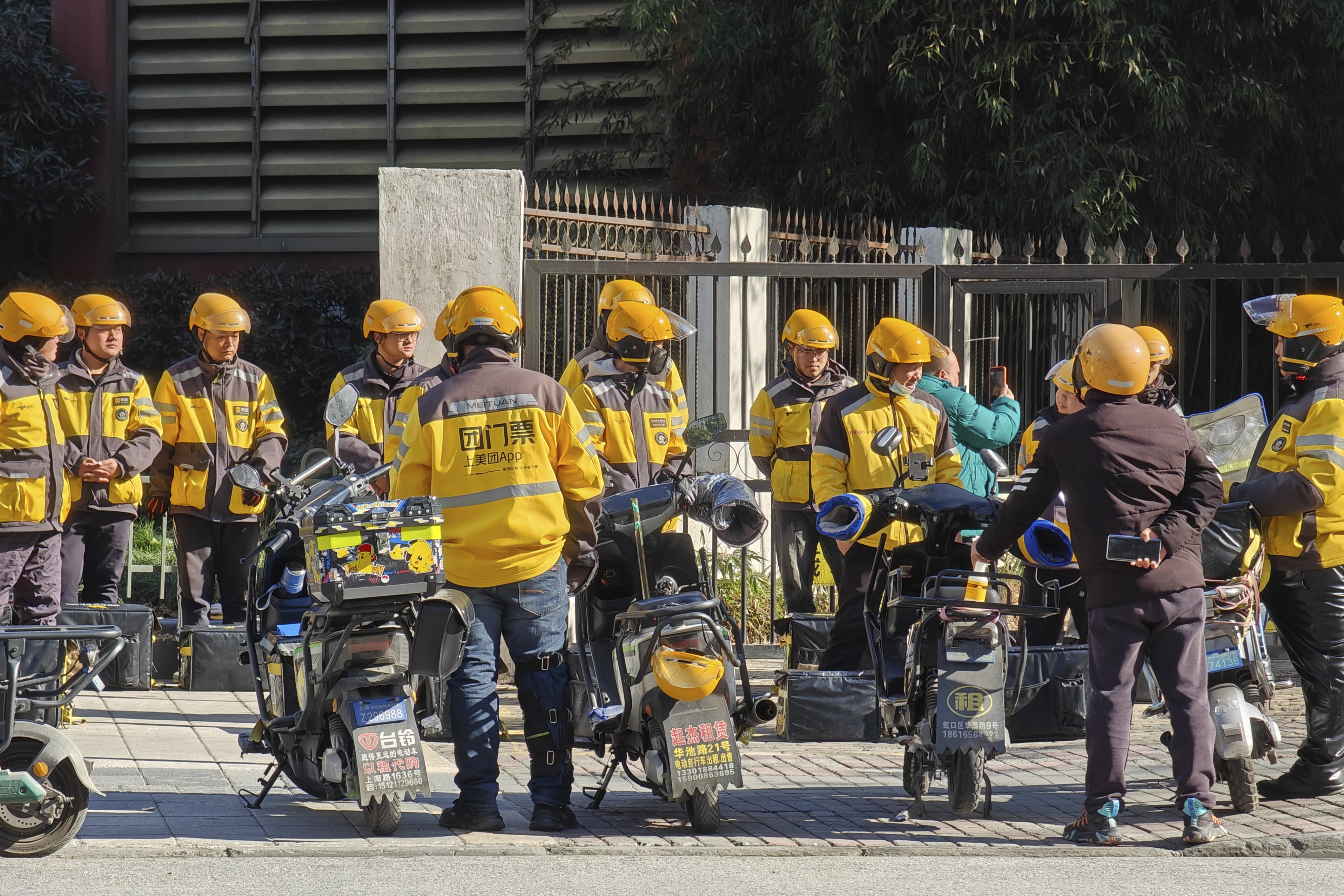 Food delivery workers are lining up to collect orders in Shanghai, China, January 14, 2024. 