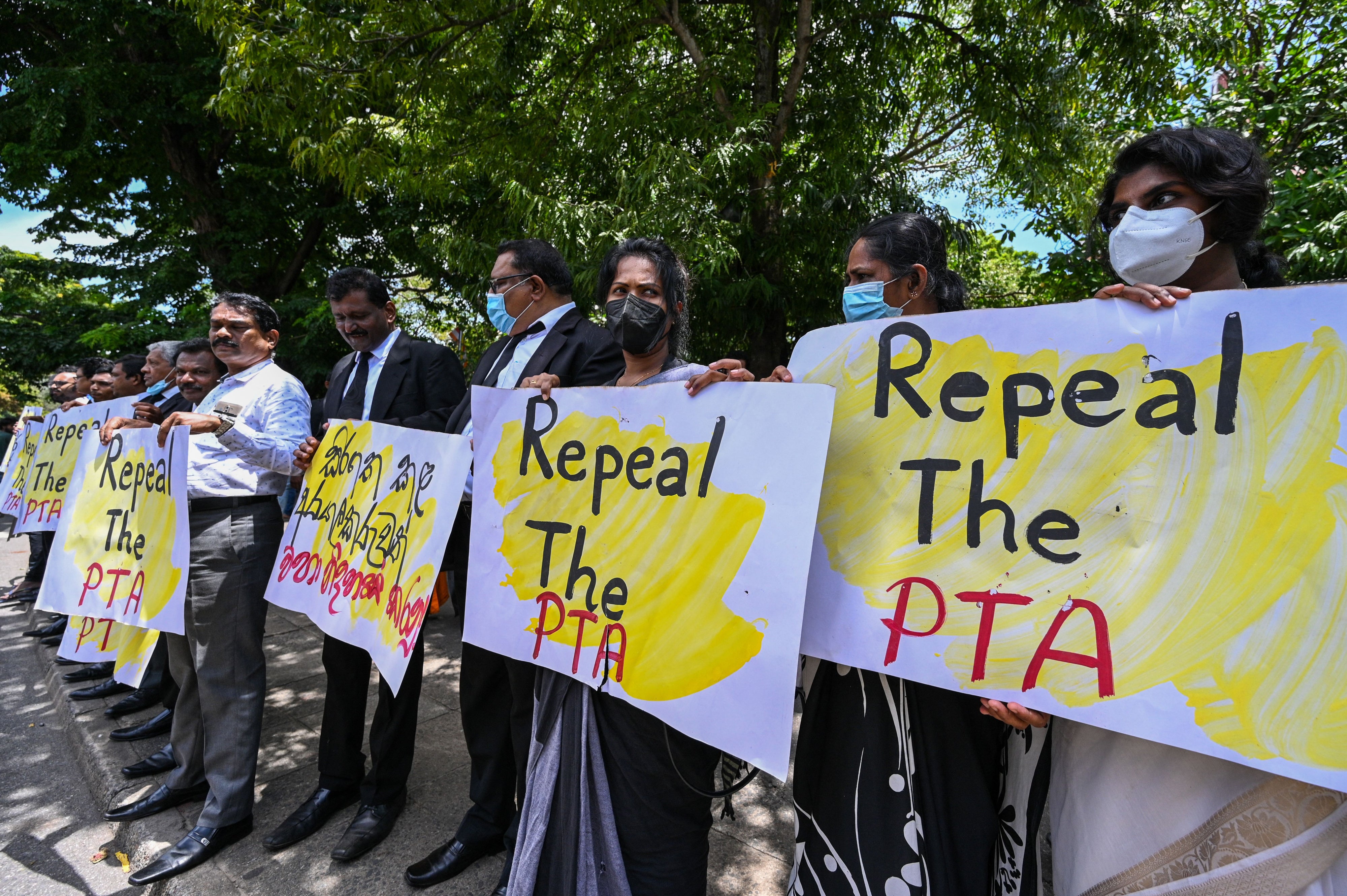 Lawyers hold signs during a protest against the Prevention of Terrorism Act. Colombo, Sri Lanka, September 23, 2022. 