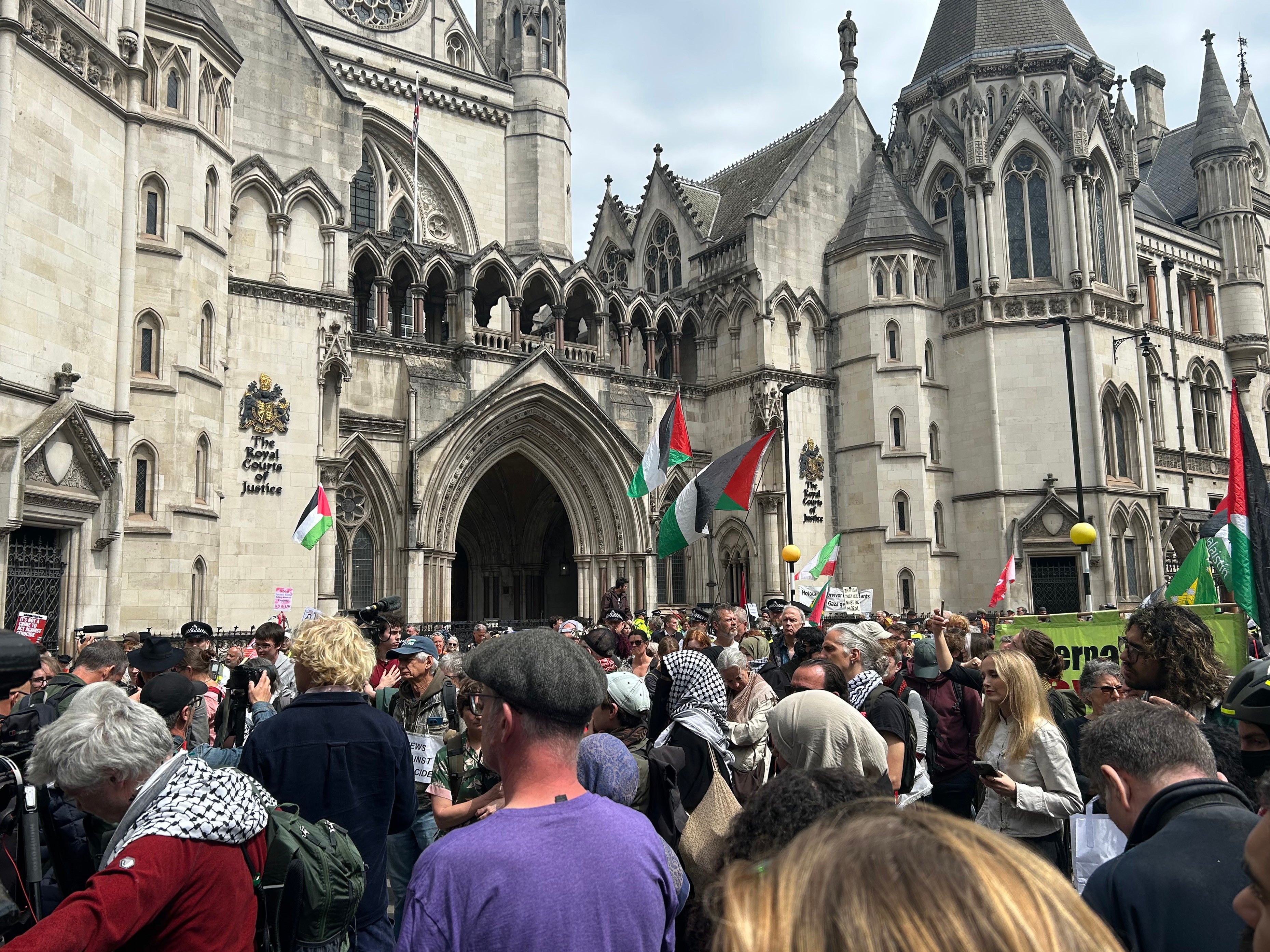 Protesters gather outside the Royal Courts of Justice on the Strand listening to the judge's statement, London, UK, June 15, 2026.