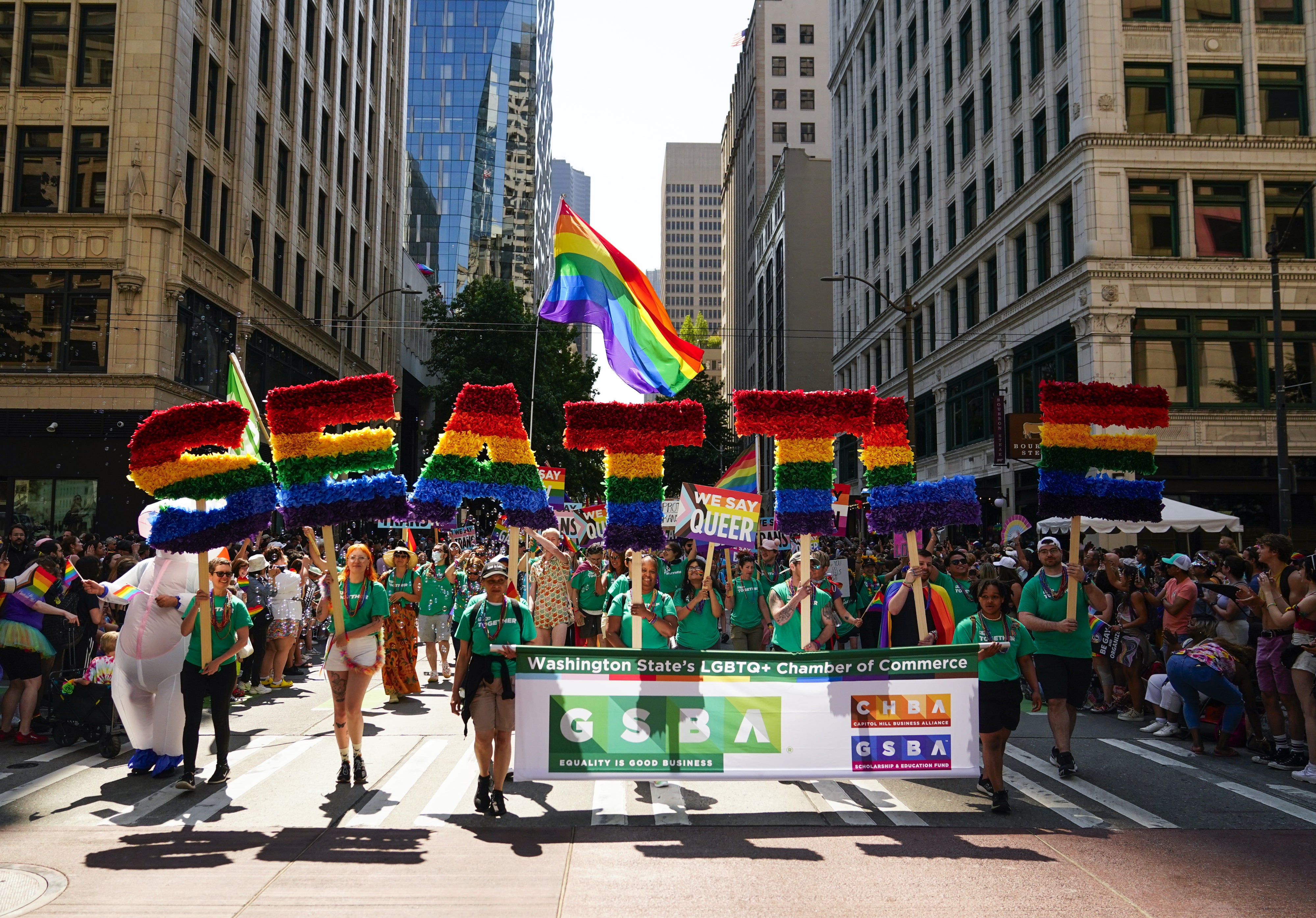 Marchers with the Greater Seattle Business Association, Washington State's LGBTQ+ and allied chamber of commerce, during the annual Seattle Pride Parade, June 25, 2023.