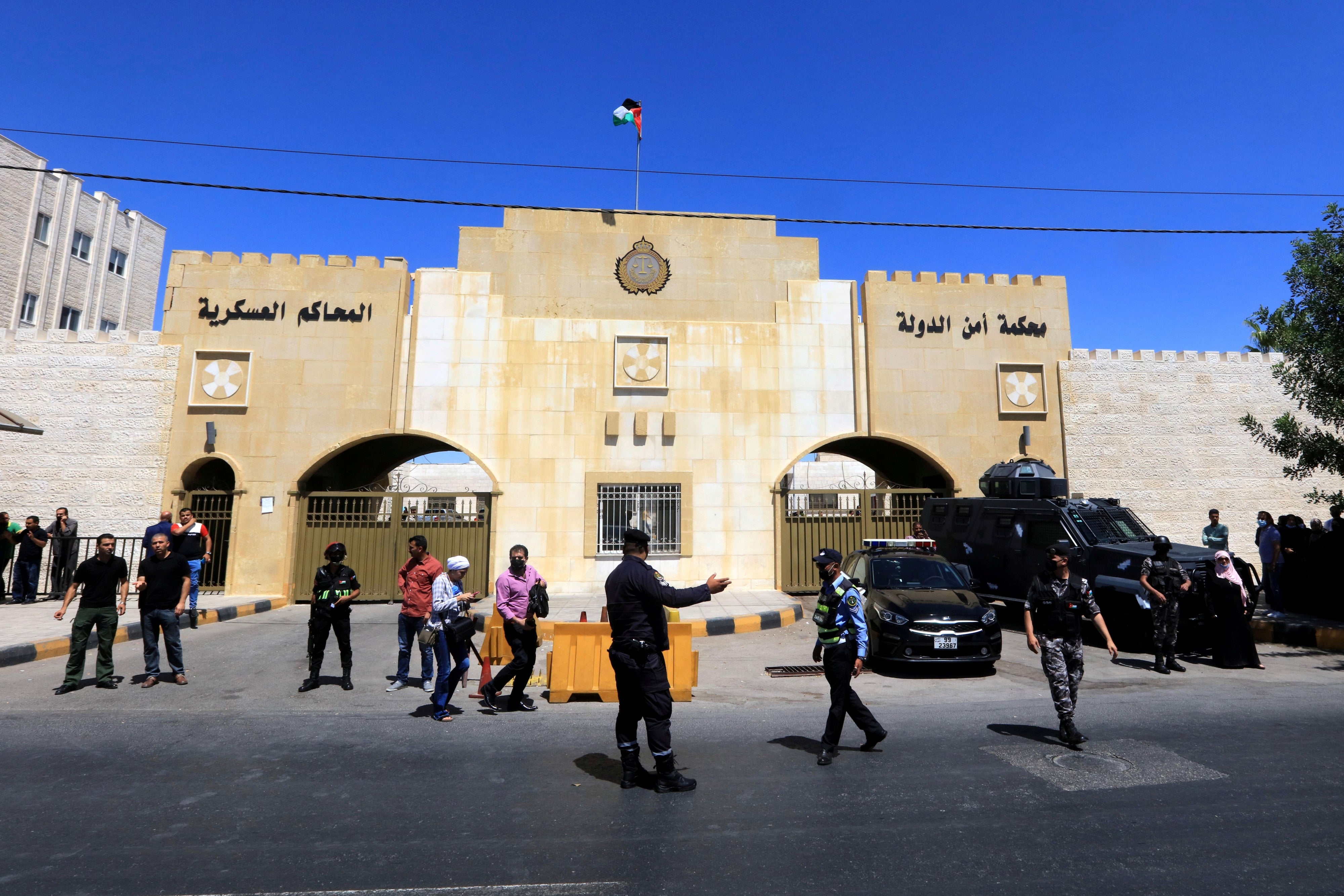 Security members stand guard outside the State Security Court in Amman, Jordan, July 12, 2021.