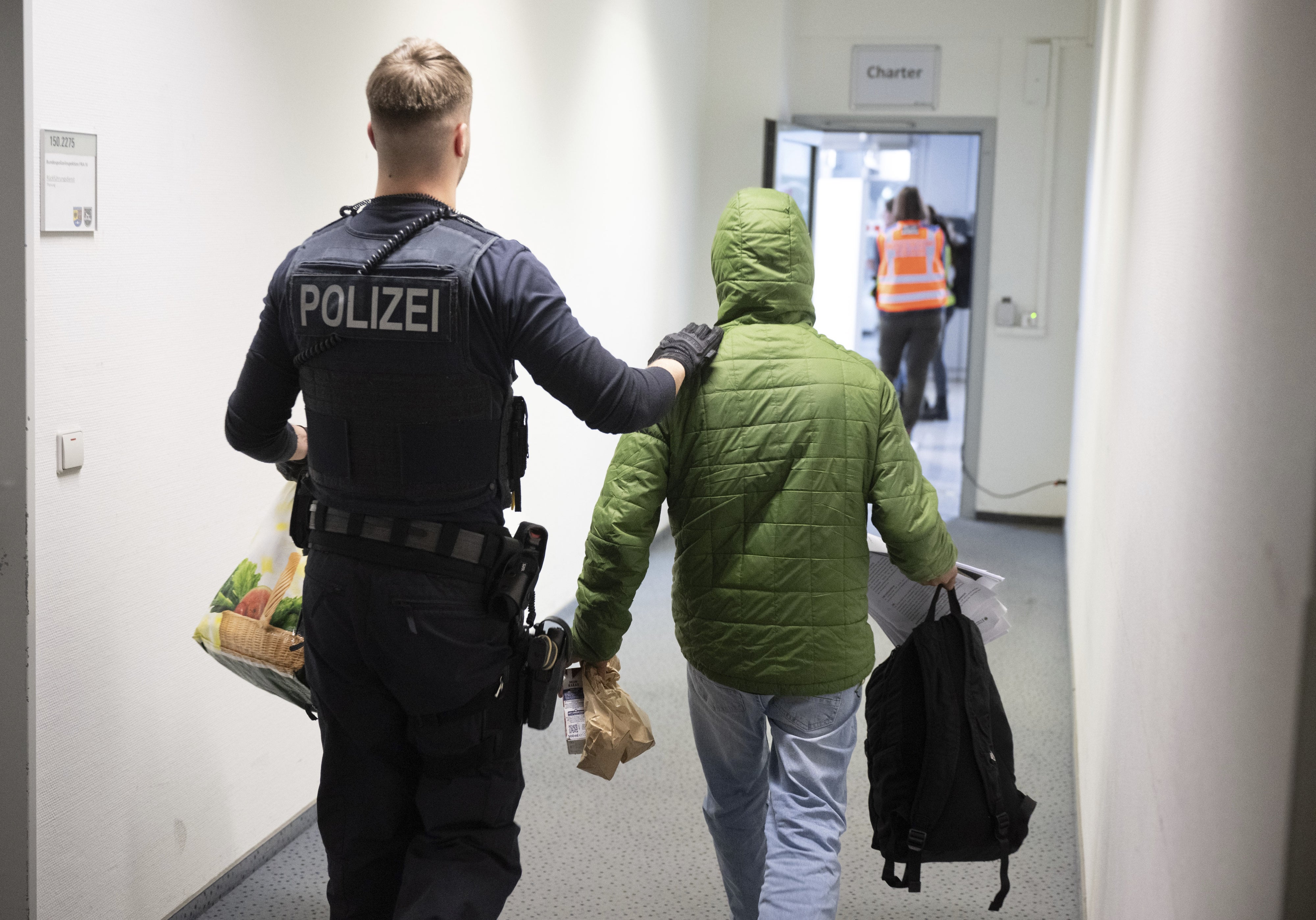 A German police officer takes a man to a deportation flight to Pakistan, February 25, 2025, Hesse, Germany.
