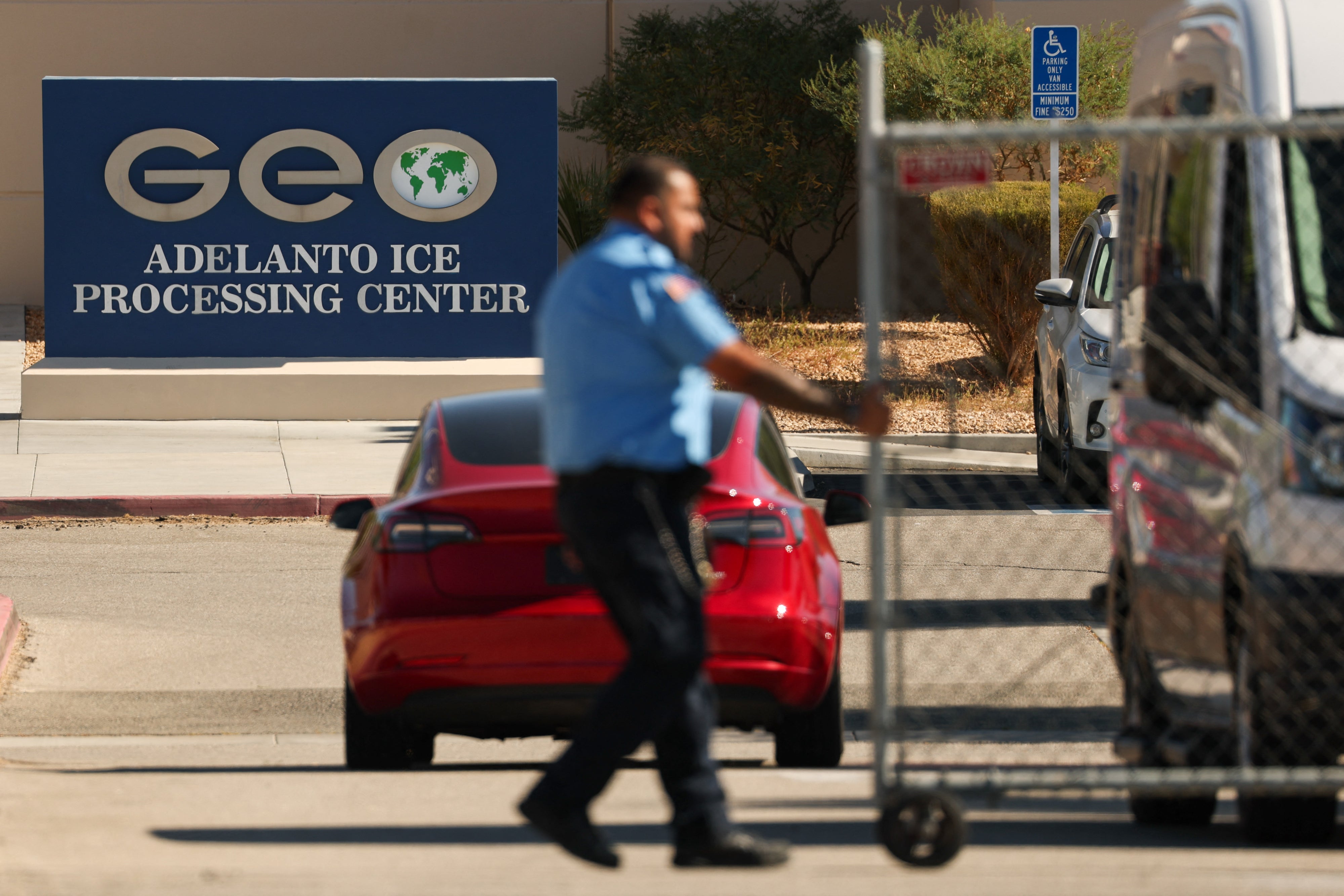 The GEO Group, Inc. logo is displayed as an officer closes a security gate 