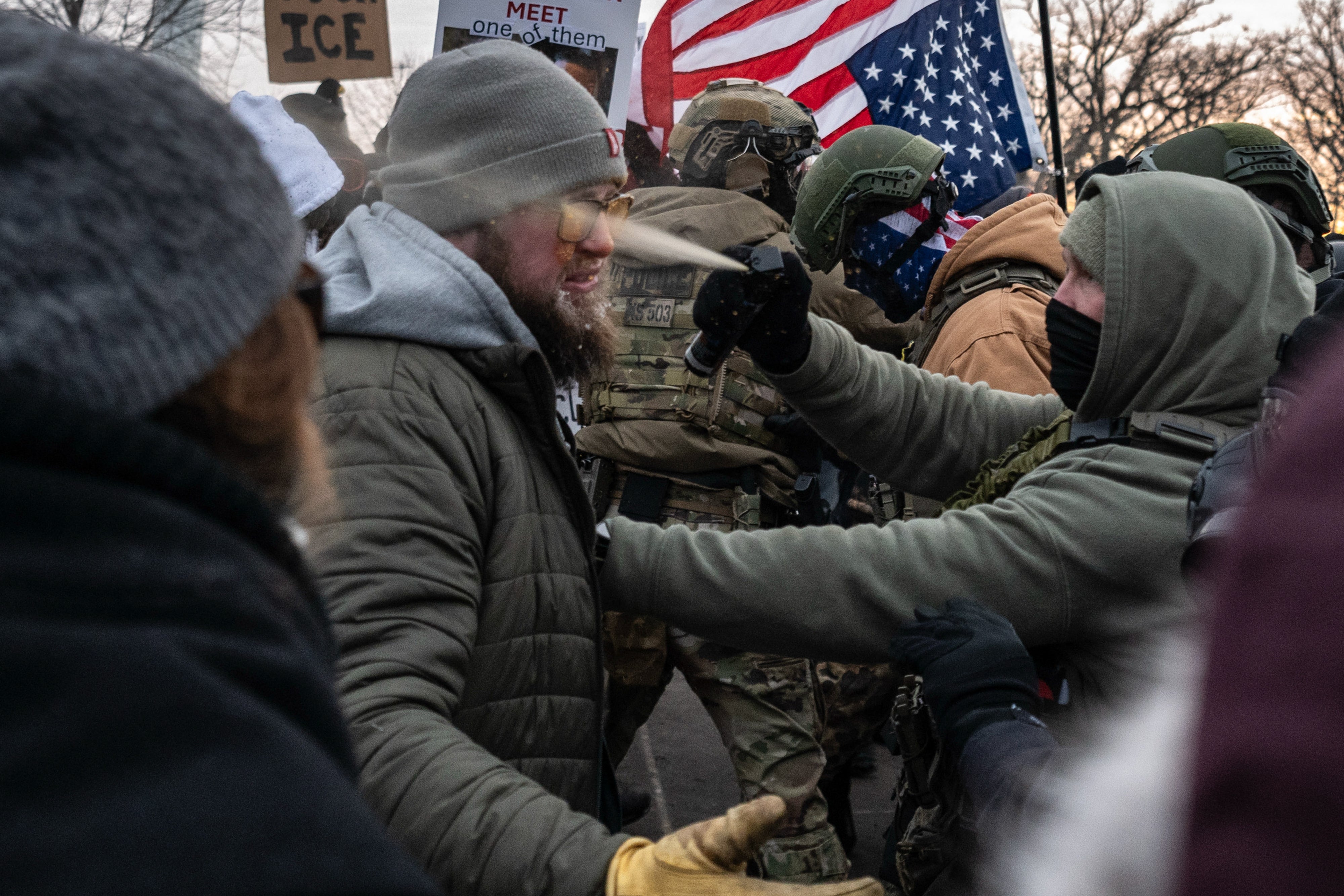 Federal law enforcement officers use pepper spray against a demonstrator
