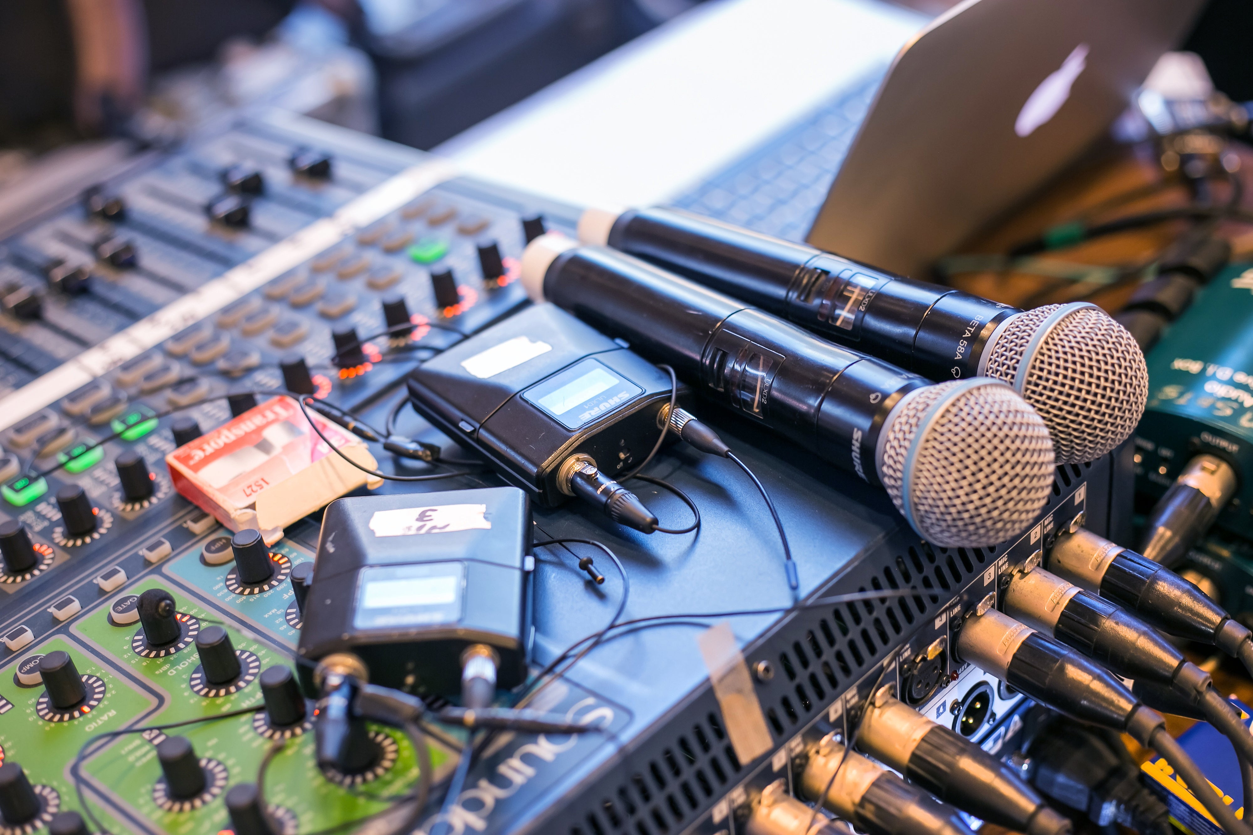 Microphones and receivers on a mixing desk. 
