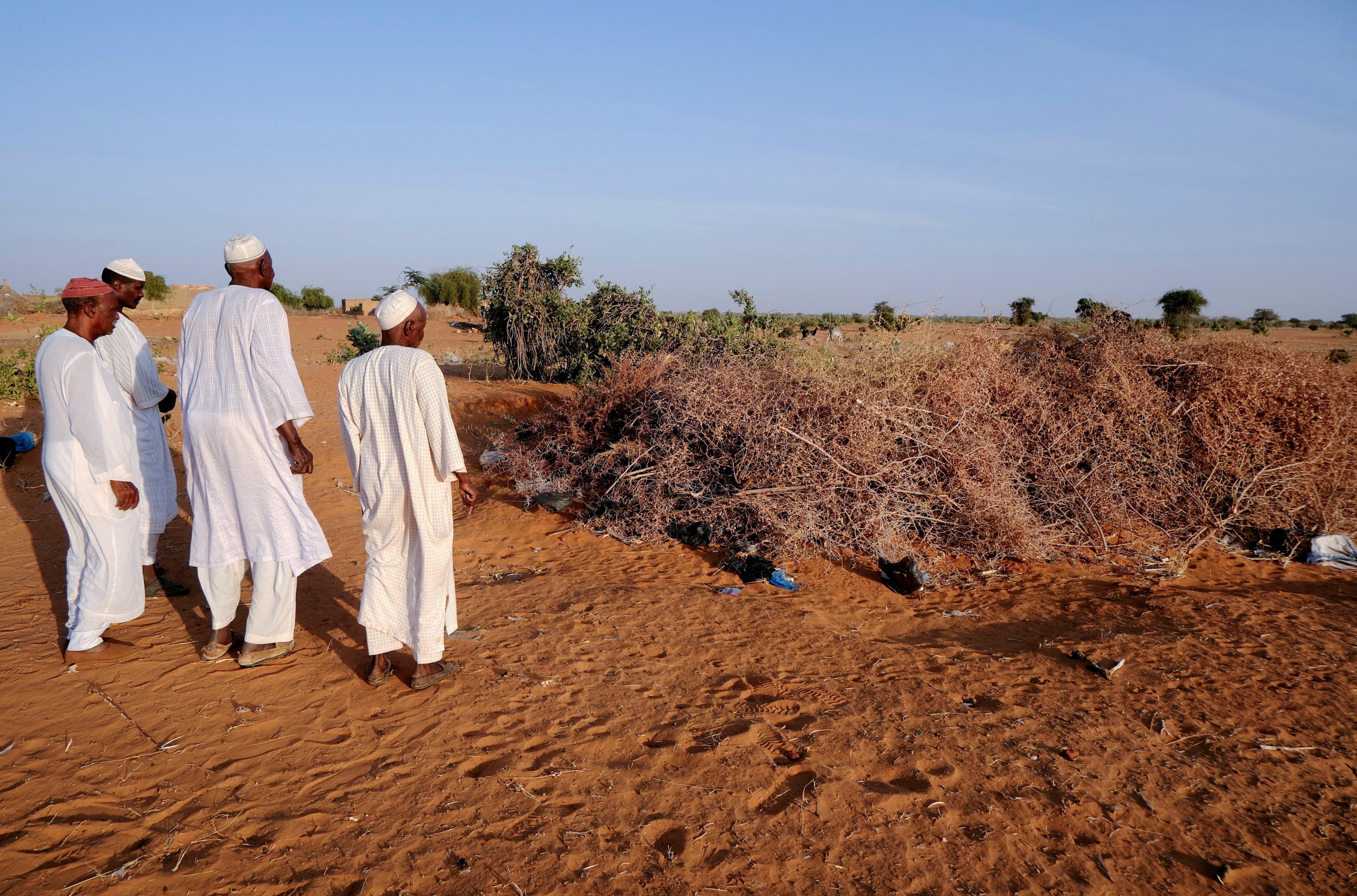 Villagers from Al-Luwaib in North Kordofan stand at a burial site for victims of a drone strike, in El Obeid, Sudan, January 14, 2026.