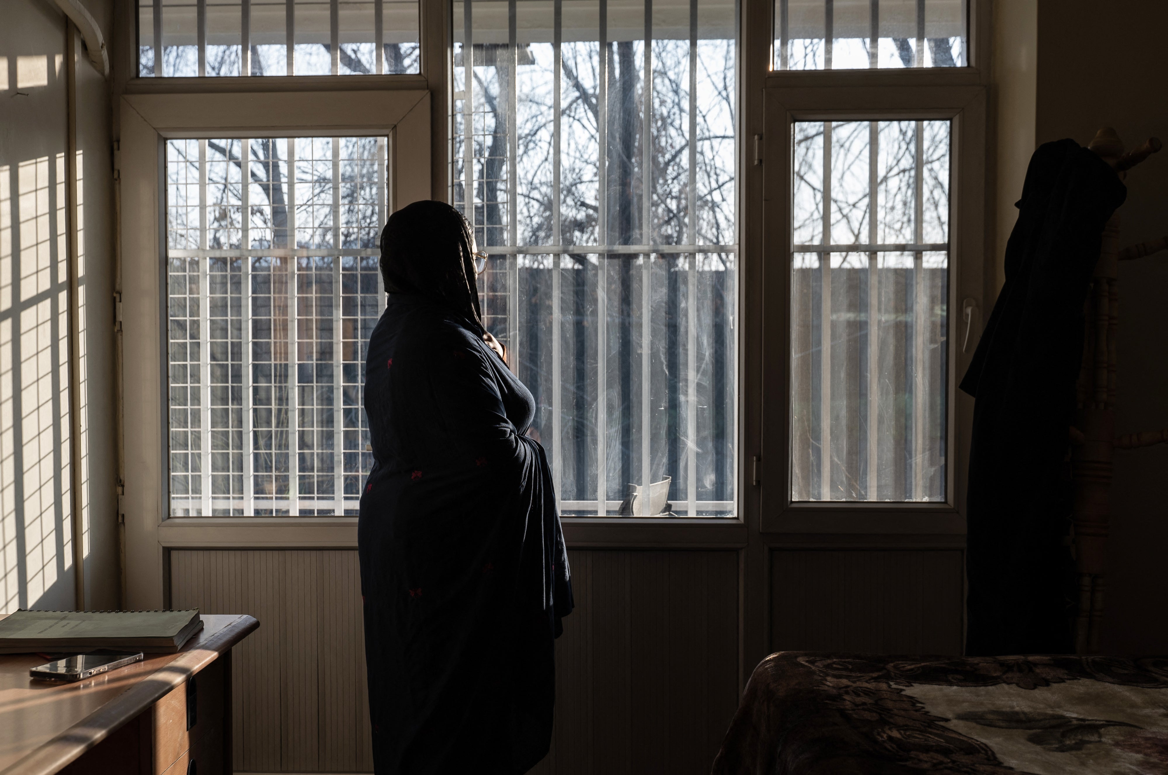 A woman looks out of a window