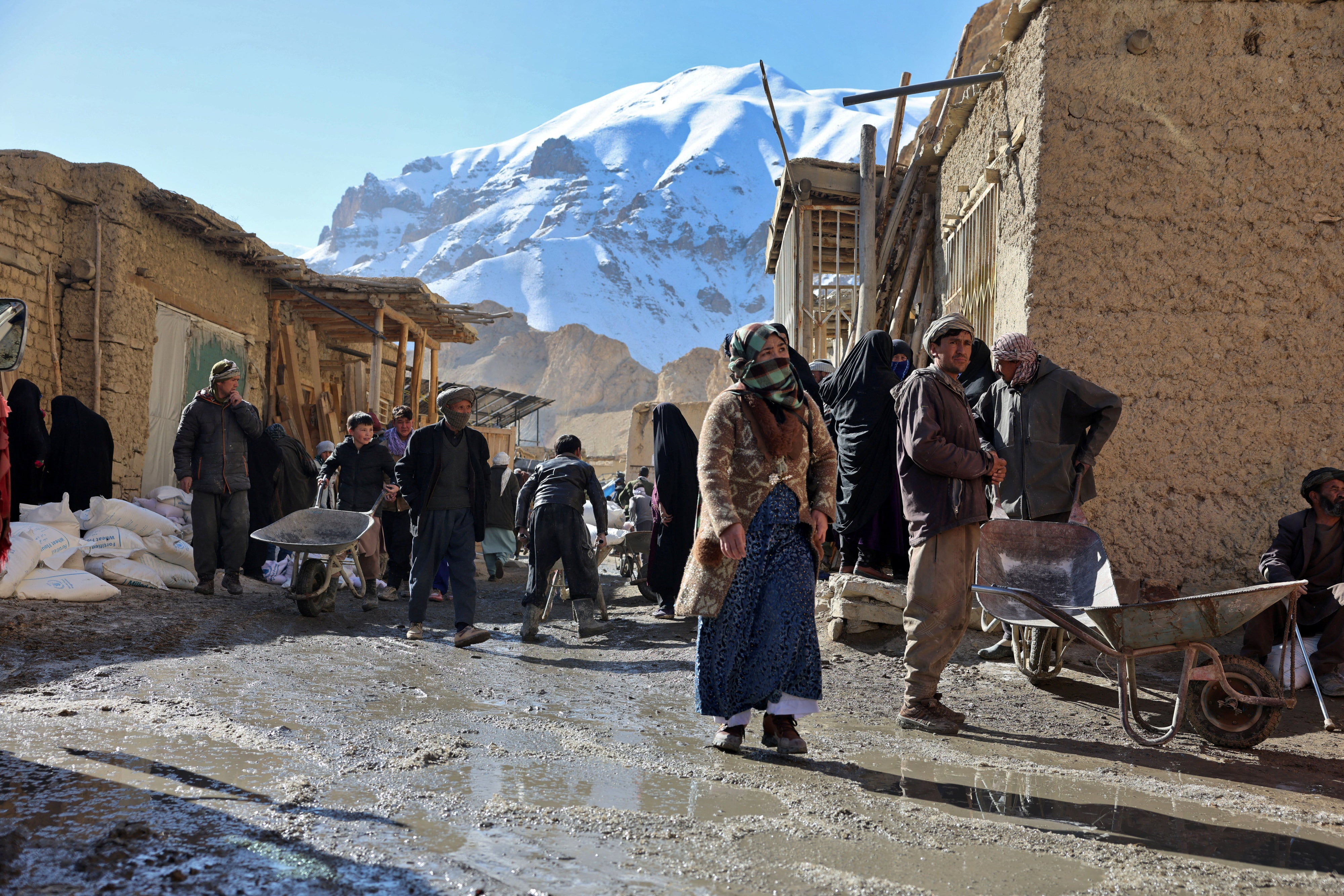 People congregate outside a World Food Programme food distribution center in Yakawlang, Bamyan province, Afghanistan, January 1, 2026. 