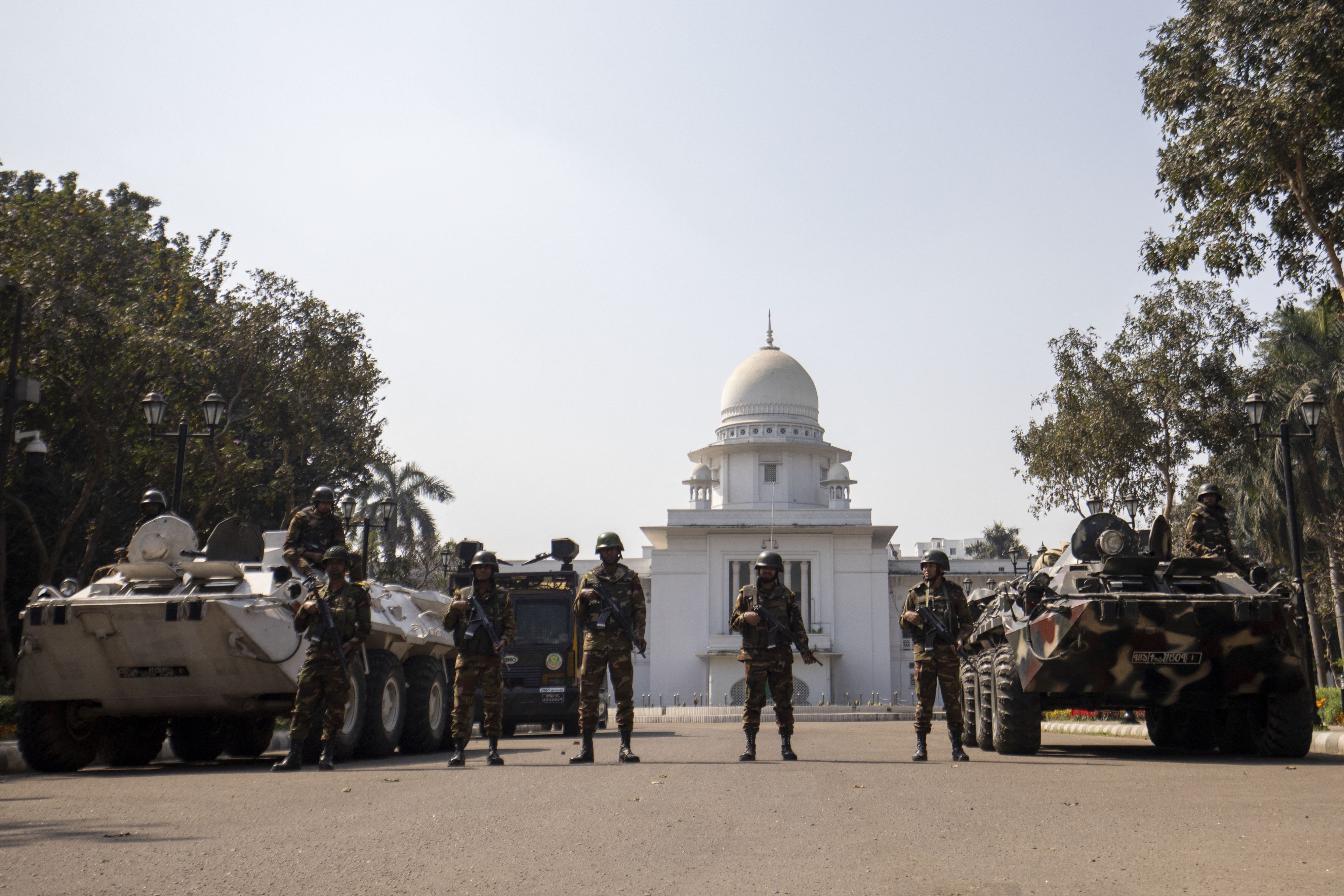 Bangladesh military and Rapid Action Battalion personnel stand guard outside the Supreme Court in Dhaka, February 8, 2025.