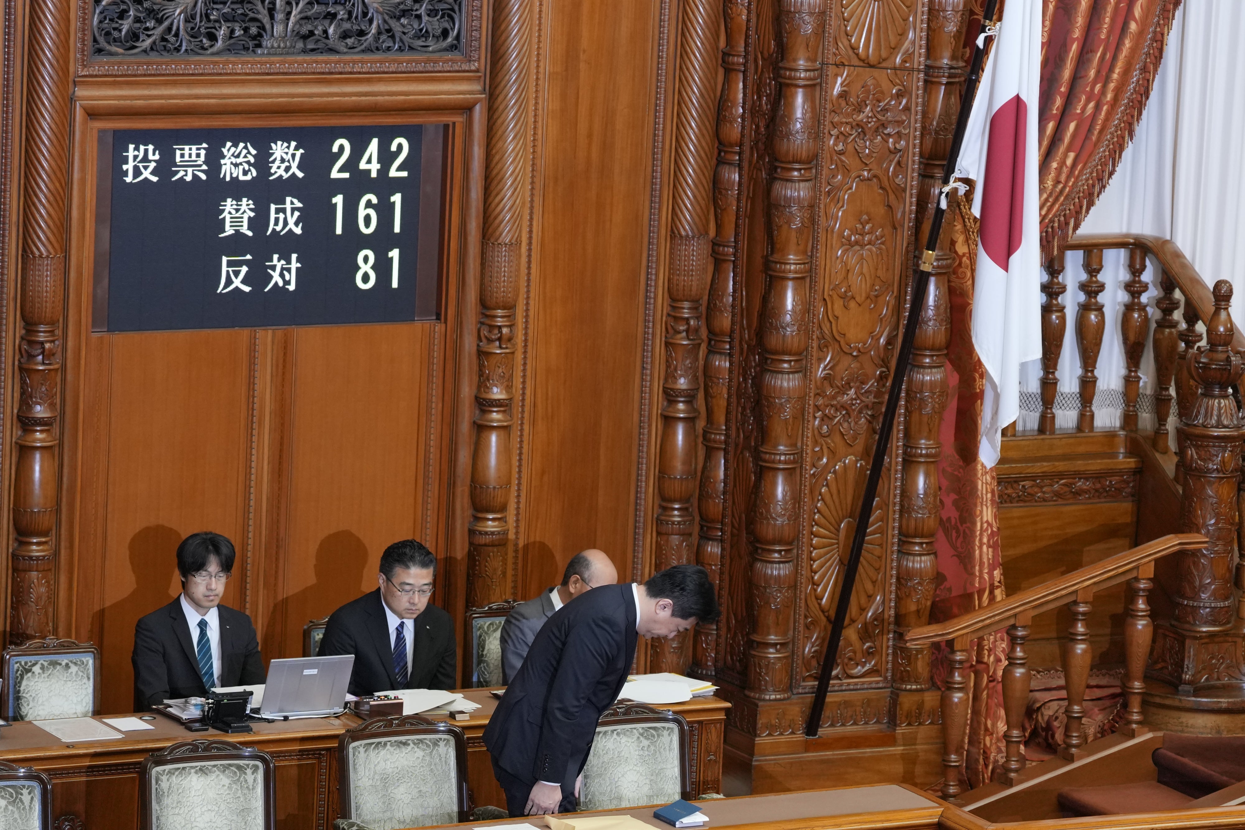 Japan's chief cabinet secretary, Minoru Kihara, bows to members of the House of Councilors after lawmakers passed a law prohibiting desecration of the national flag, Tokyo, July 17, 2026.