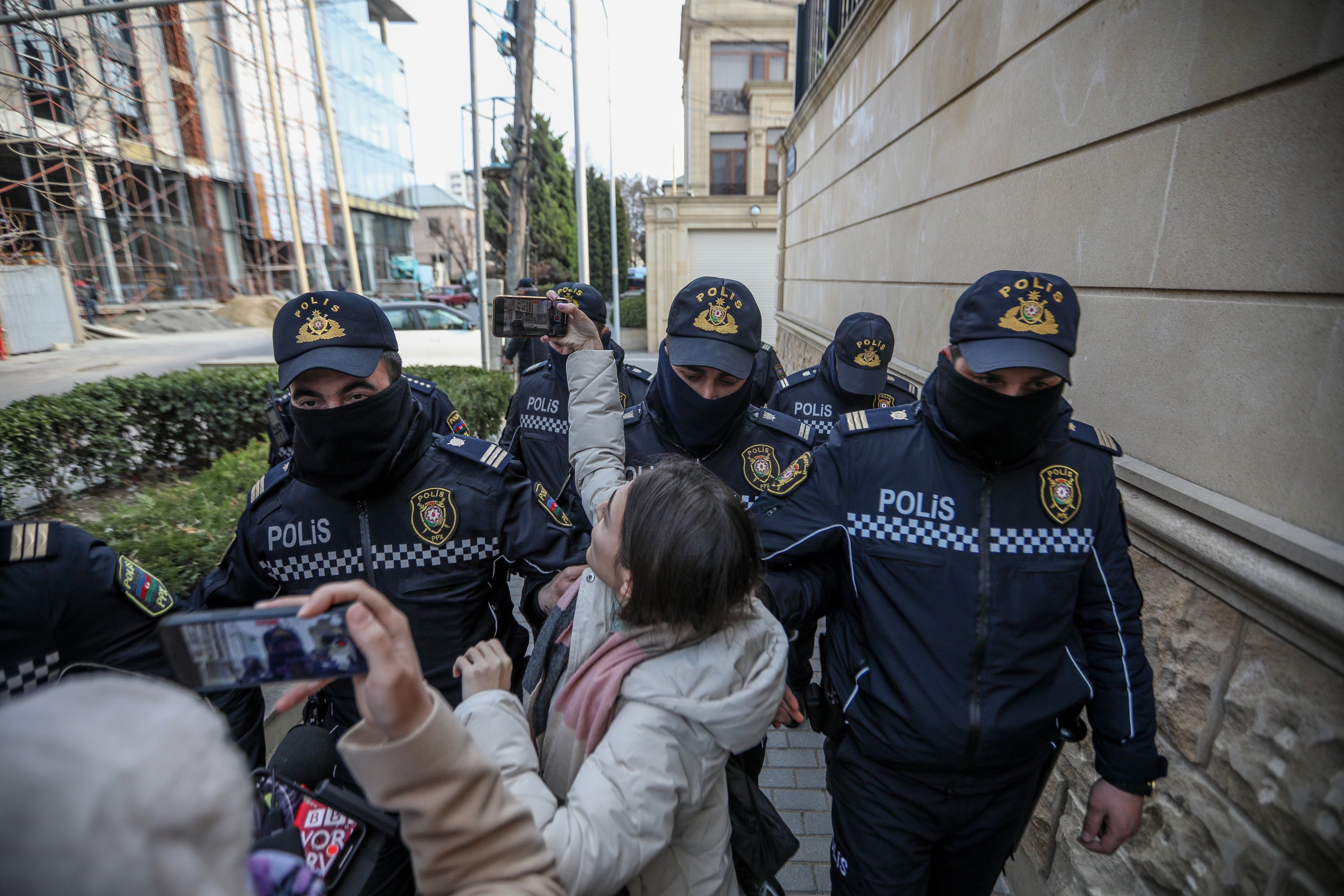 Police removing journalists from Toplum TV on March 6, 2024 in Baku, Azerbaijan.